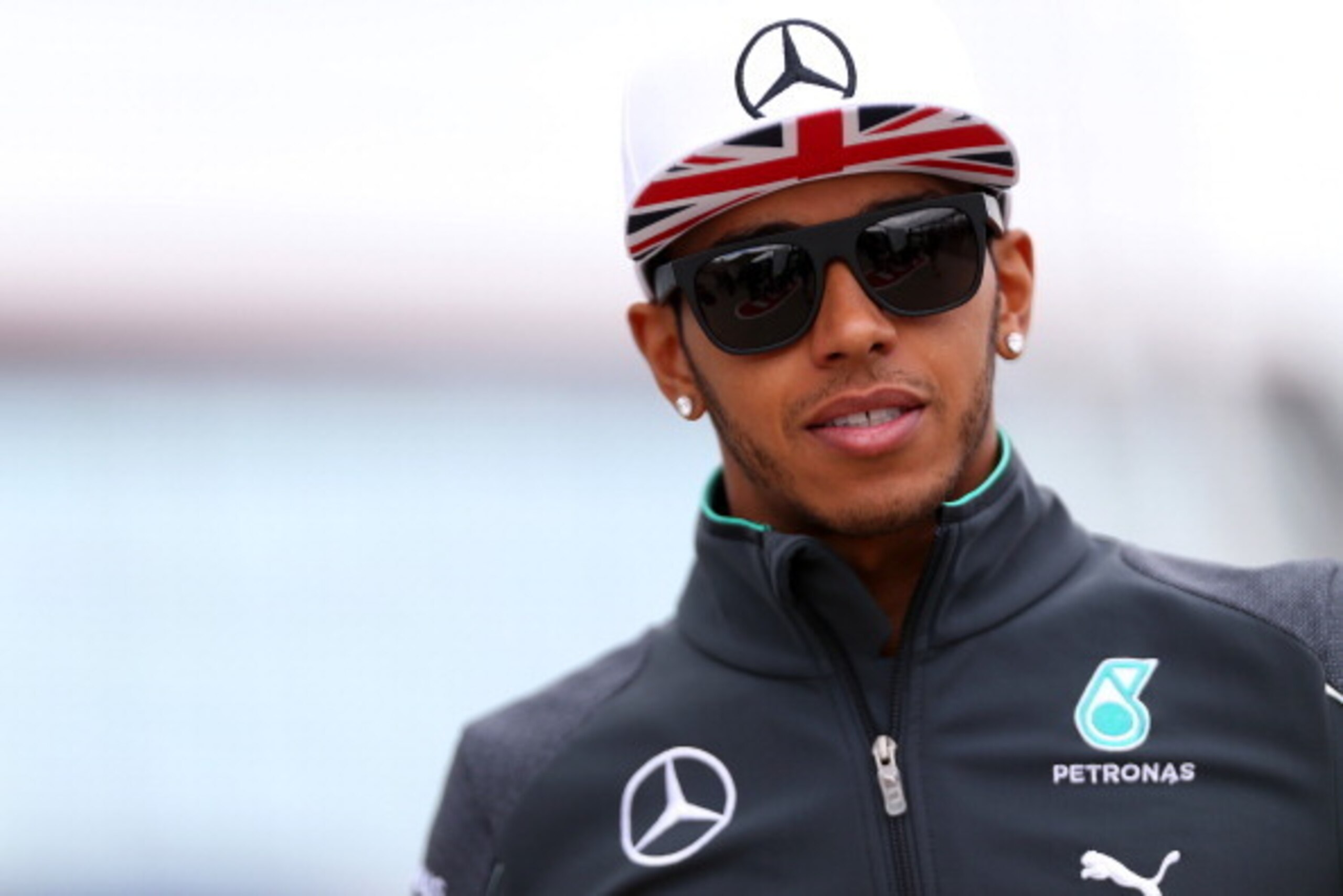 NORTHAMPTON, ENGLAND - JULY 05:  Lewis Hamilton of Great Britain and Mercedes GP walks through the paddock during qualifying ahead of the British Formula One Grand Prix at Silverstone Circuit on July 5, 2014 in Northampton, United Kingdom.  (Photo by Mark