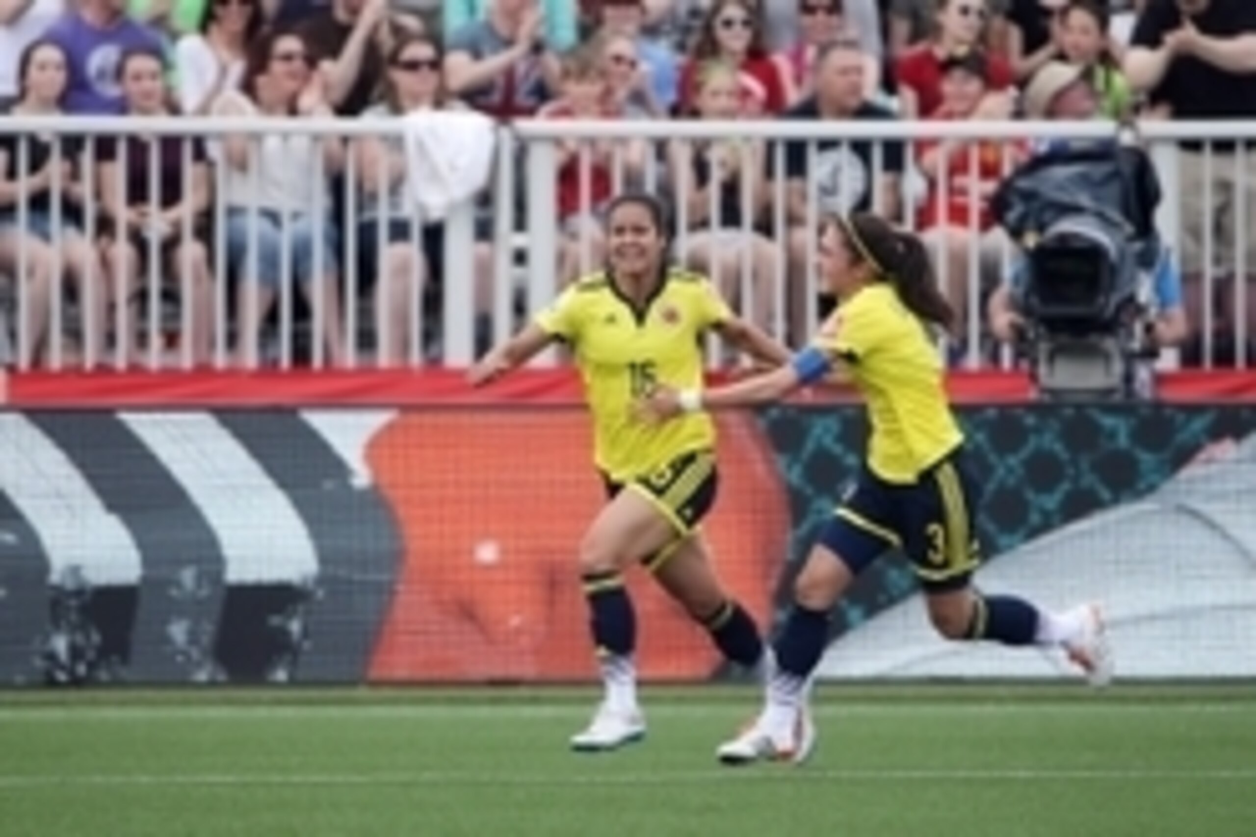 Jun 13, 2015; Moncton, New Brunswick, CAN; Colombia forward Lady Andrade (16) celebrates with Colombia midfielder Natalia Gaitan (3) after scoring a goal during the first half against France in a Group F soccer match in the 2015 FIFA women's World Cup at Jun 13, 2015; Moncton, New Brunswick, CAN; Colombia forward Lady Andrade (16) celebrates with Colombia midfielder Natalia Gaitan (3) after scoring a goal during the first half against France in a Group F soccer match in the 2015 FIFA women's World Cup at