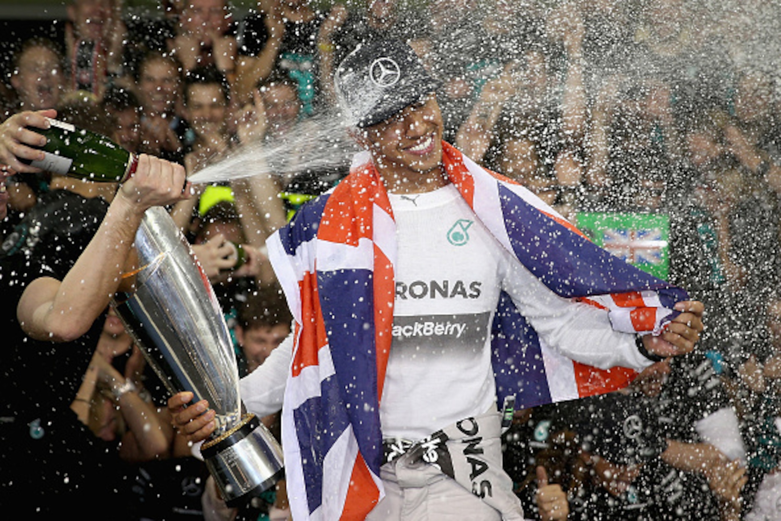 ABU DHABI, UNITED ARAB EMIRATES - NOVEMBER 23:  Lewis Hamilton of Great Britain and Mercedes GP celebrates with his team after winning the World Championship after the Abu Dhabi Formula One Grand Prix at Yas Marina Circuit on November 23, 2014 in Abu Dhab
