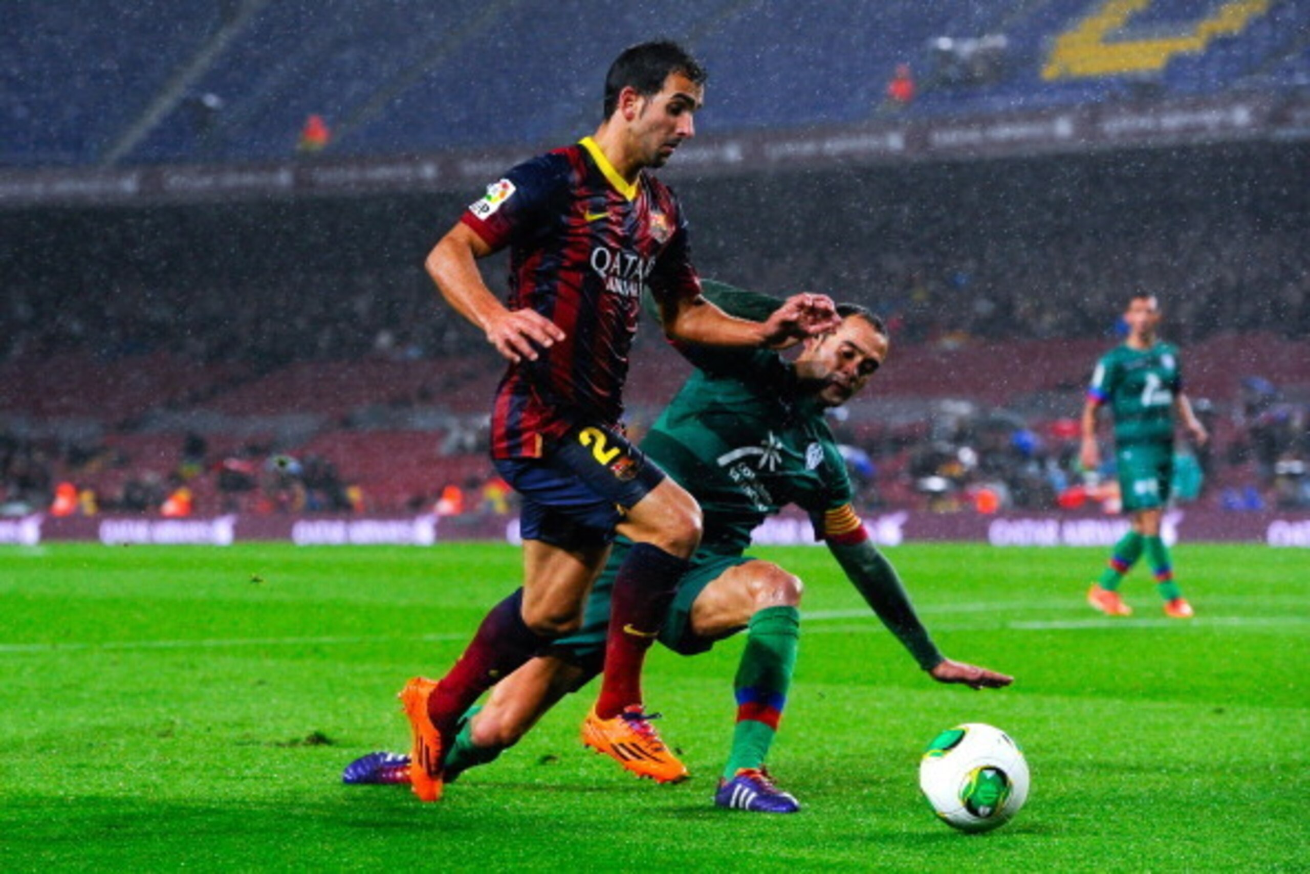 BARCELONA, SPAIN - JANUARY 29:  Martin Montoya of FC Barcelona duels for the ball with Juanfran of Levante UD during the Copa del Rey Quarter Final 2nd leg match between FC Barcelona and Levante U.D Camp Nou on January 29, 2014 in Barcelona, Spain.  (Phot