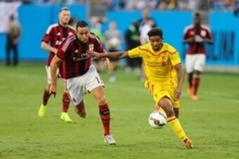 Aug 2, 2014; Charlotte, NC, USA; AC Milan midfielder Rami Adil (13) and Liverpool forward Jordon Ibe (33) race to the ball during an international friendly at Bank of America Stadium. Mandatory Credit: Jim Dedmon-USA TODAY Sports