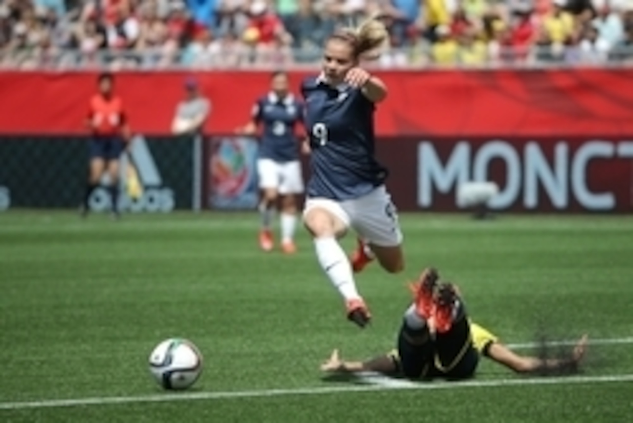 Jun 13, 2015; Moncton, New Brunswick, CAN; Colombia midfielder Carolina Arias (17) falls as France forward Eugenie Le Sommer (9) chases the ball during the first half in a Group F soccer match in the 2015 FIFA women's World Cup at Moncton Stadium. Mandato