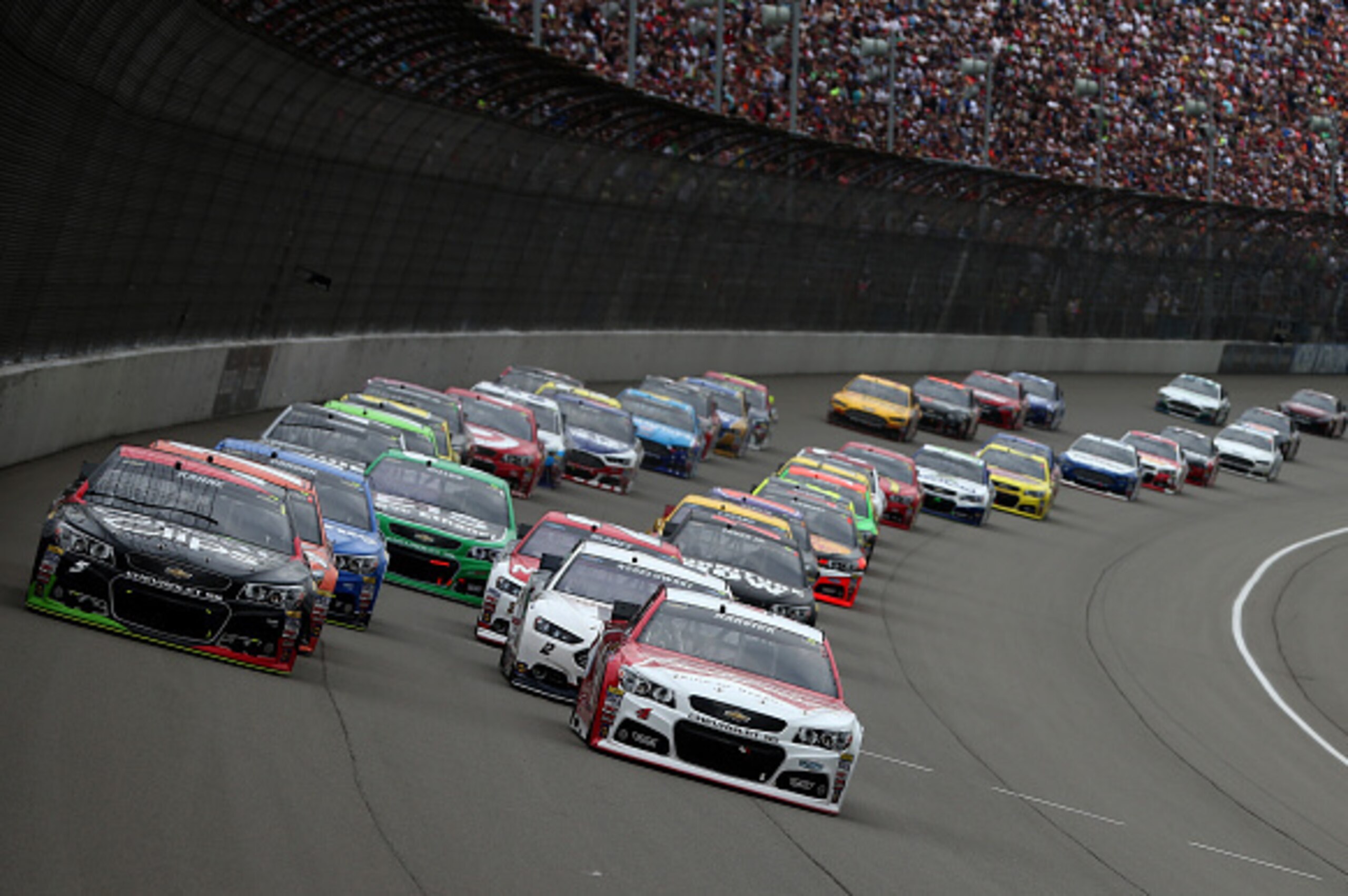 BROOKLYN, MI - JUNE 14:  Kasey Kahne, driver of the #5 Great Clips Chevrolet, and Kevin Harvick, driver of the #4 Budweiser/Jimmy John's Chevrolet, lead the field to start the NASCAR Sprint Cup Series Quicken Loans 400 at Michigan International Speedway o