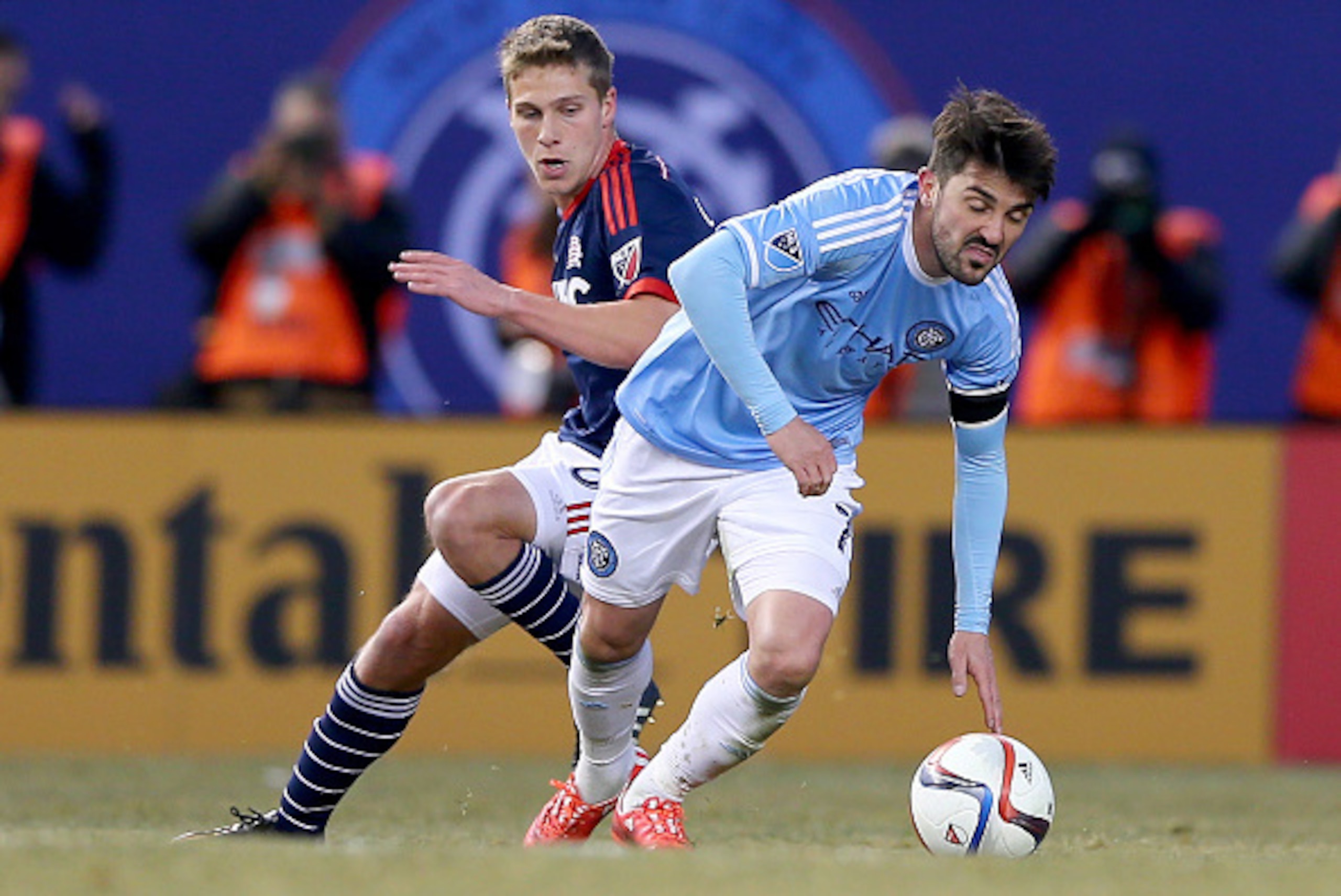 NEW YORK, NY - MARCH 15:  David Villa #7 of New York City FC tries to keep the ball as Scott Caldwell #6 of New England Revolution defends during the inaugural game of the New York City FC at Yankee Stadium on March 15, 2015 in the Bronx borough of New Yo