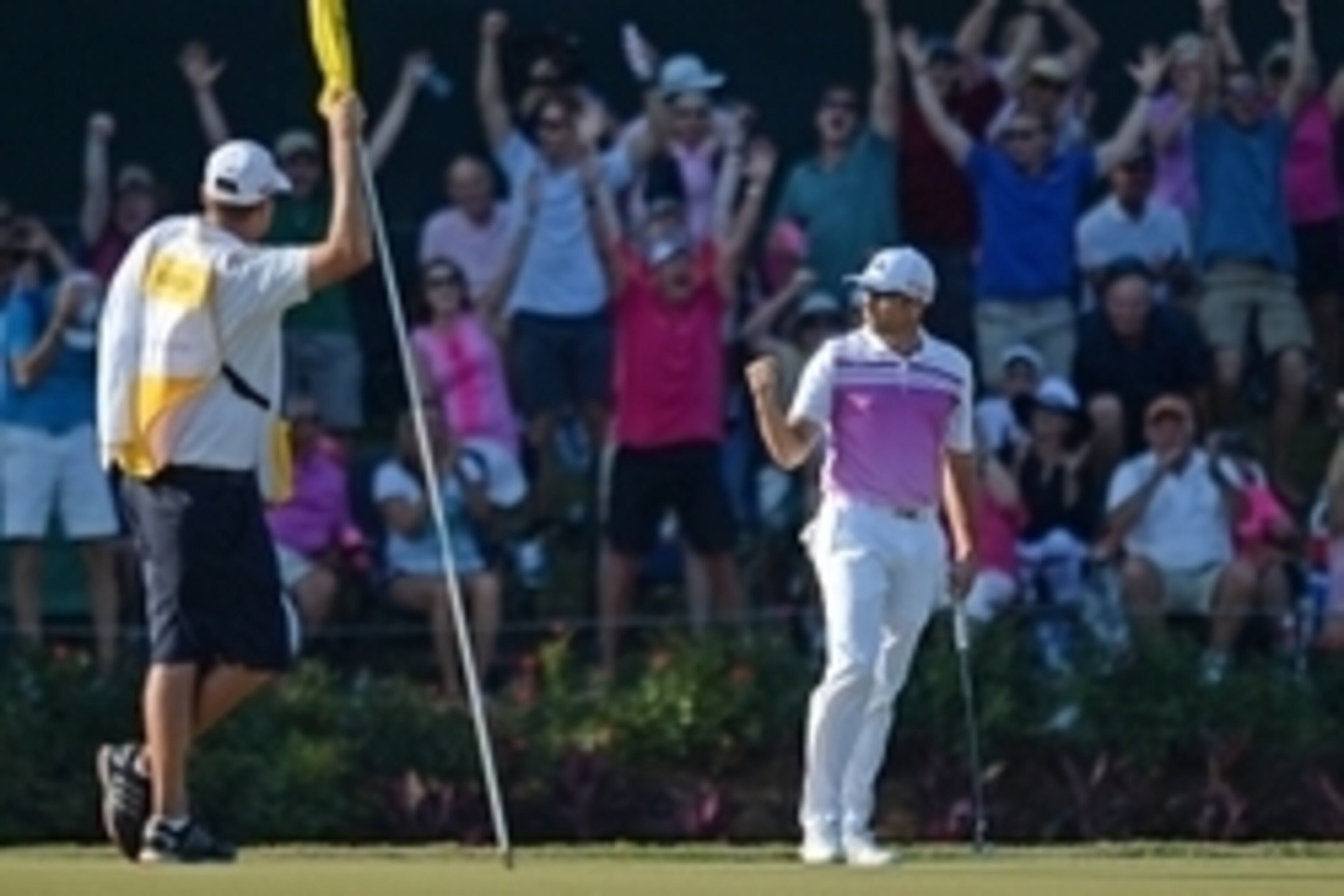 May 10, 2015; Ponte Vedra Beach, FL, USA; Sergio Garcia (right) pumps his fist after making a birdie putt on the 17th green during the final round at TPC Sawgrass - Stadium Course. Mandatory Credit: Jake Roth-USA TODAY Sports