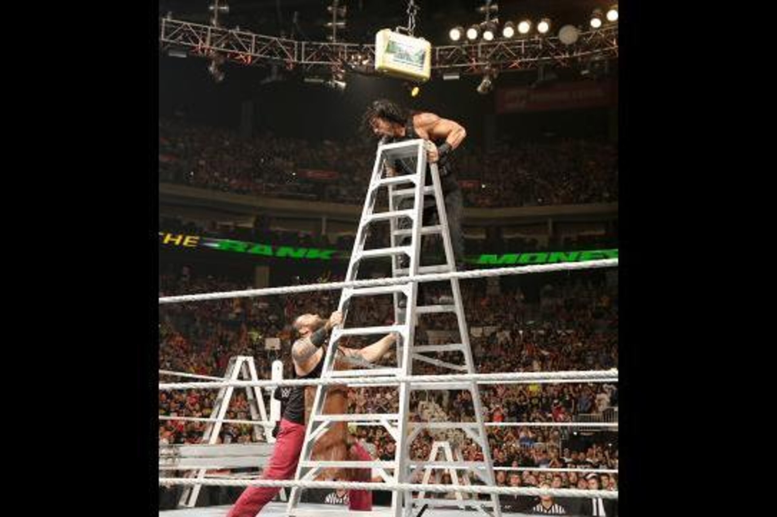 Bray Wyatt attacks Roman Reigns.
