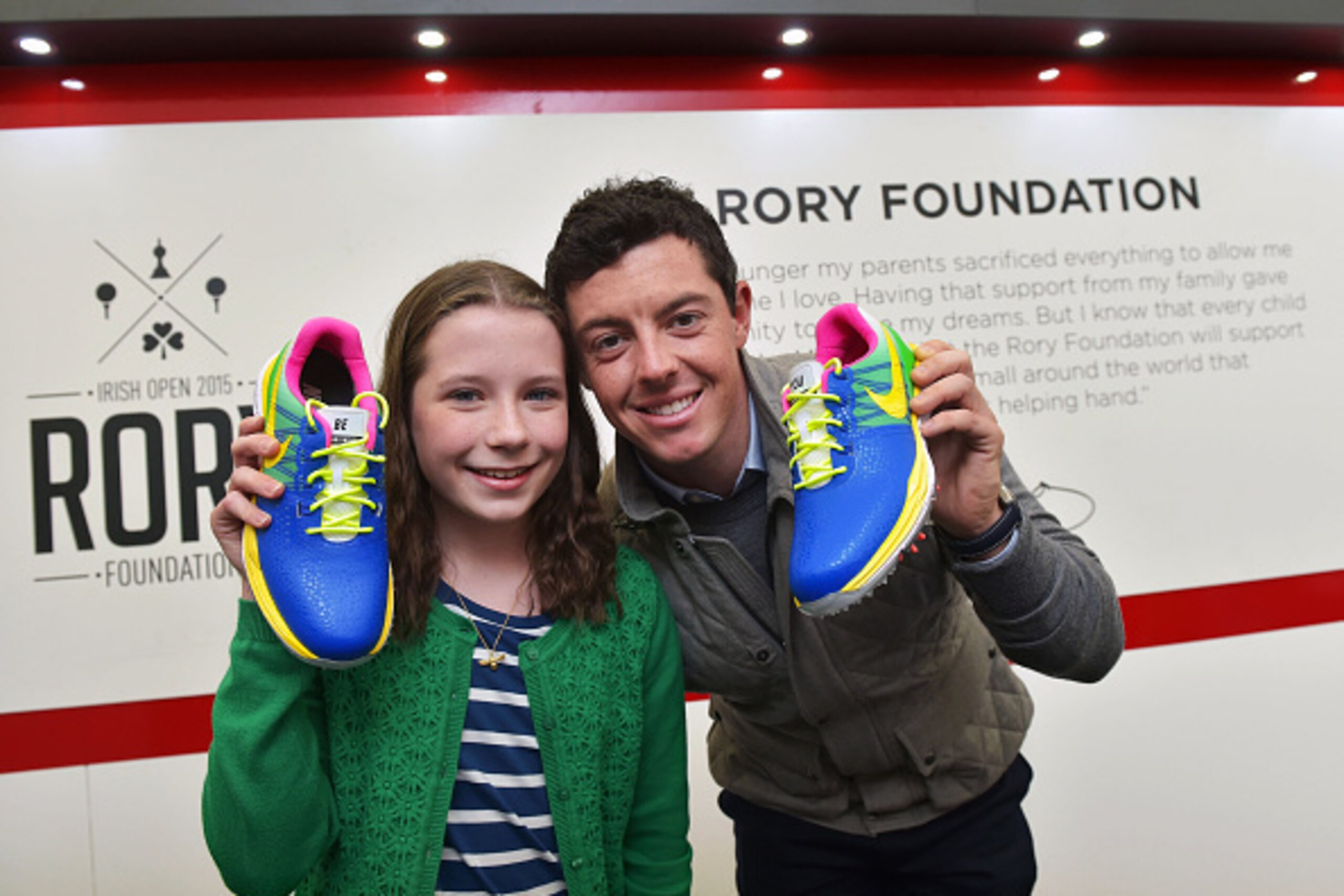 NEWCASTLE, NORTHERN IRELAND - MAY 31:  Alex Kernaghan (R) aged 12 who is supported by Cancer Fund For Children and who designed Rory McIlroy's Nike golf shoes for the final round of the Dubai Duty Free Irish Open hosted by the Rory foundation meets her he