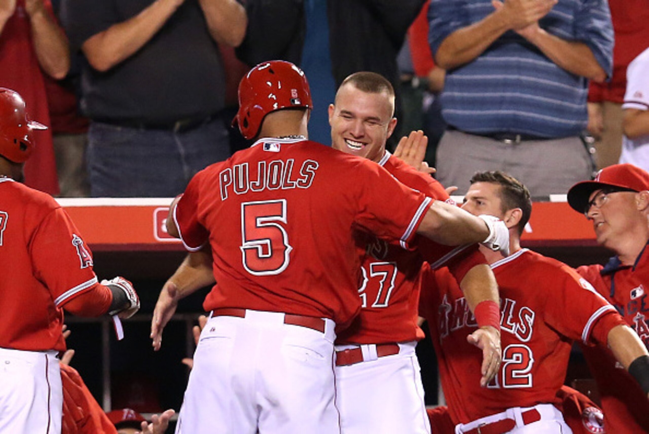 ANAHEIM, CA - JUNE 01:  Albert Pujols #5 of the Los Angeles Angels of Anaheim is greeted by Mike Trout #27 as he returns to the dugout after hitting a two run home run in the eighth inning against the Tampa Bay Rays reacts at Angel Stadium of Anaheim on J
