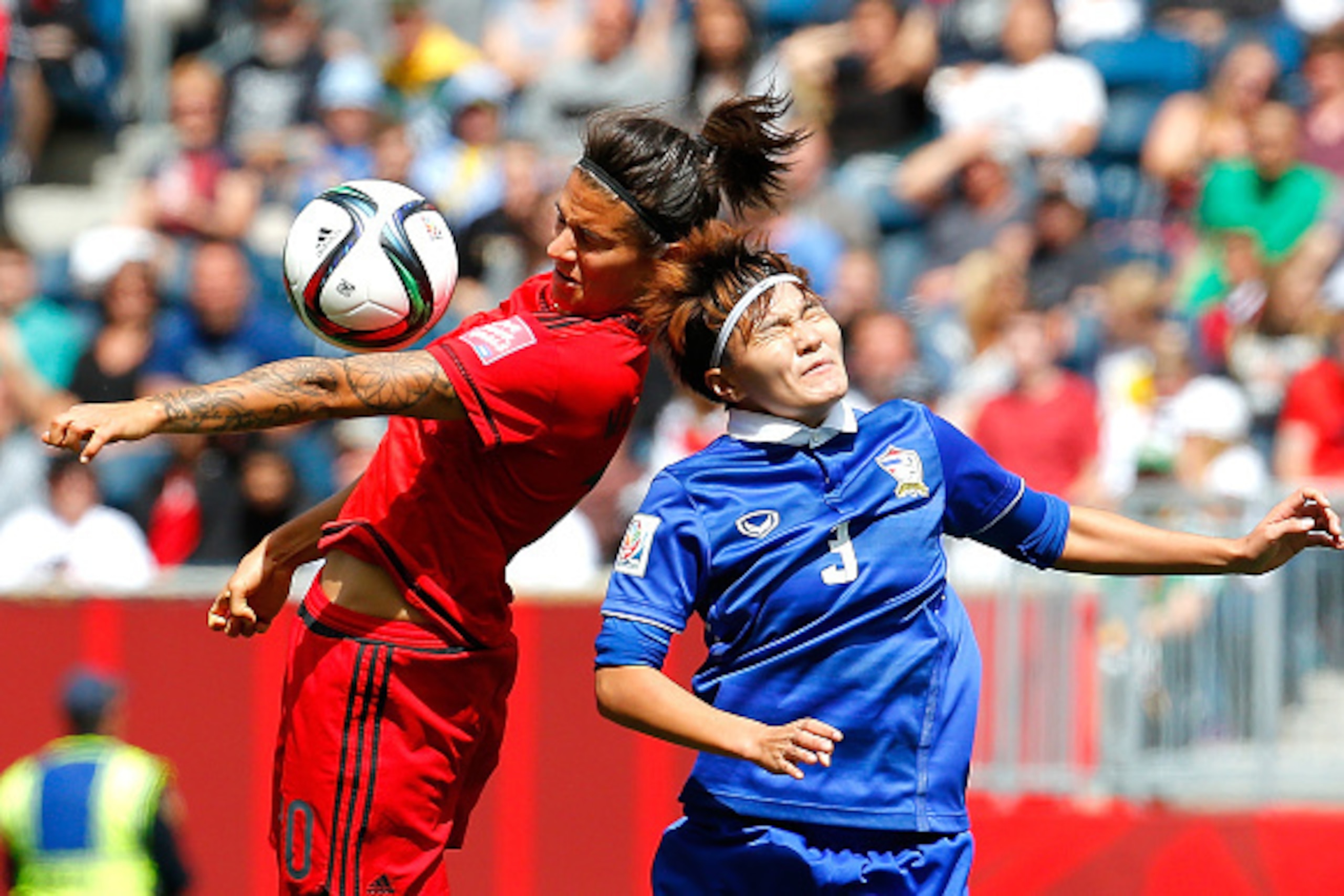 WINNIPEG, MB - JUNE 15:  Natthakarn Chinwong #3 of Thailand challenges Dzsenifer Marozsan #10 of Germany during the FIFA Women's World Cup Canada 2015 match between Thailand and Germany at Winnipeg Stadium on June 15, 2015 in Winnipeg, Canada.  (Photo by 