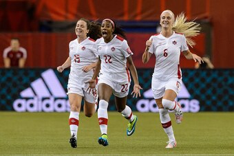 MONTREAL, QC - JUNE 15:  Ashley Lawrence #22 of Canada celebrates her goal with teammates in the first half during the 2015 FIFA Women's World Cup Group A match against the Netherlands at Olympic Stadium on June 15, 2015 in Montreal, Quebec, Canada. (Phot