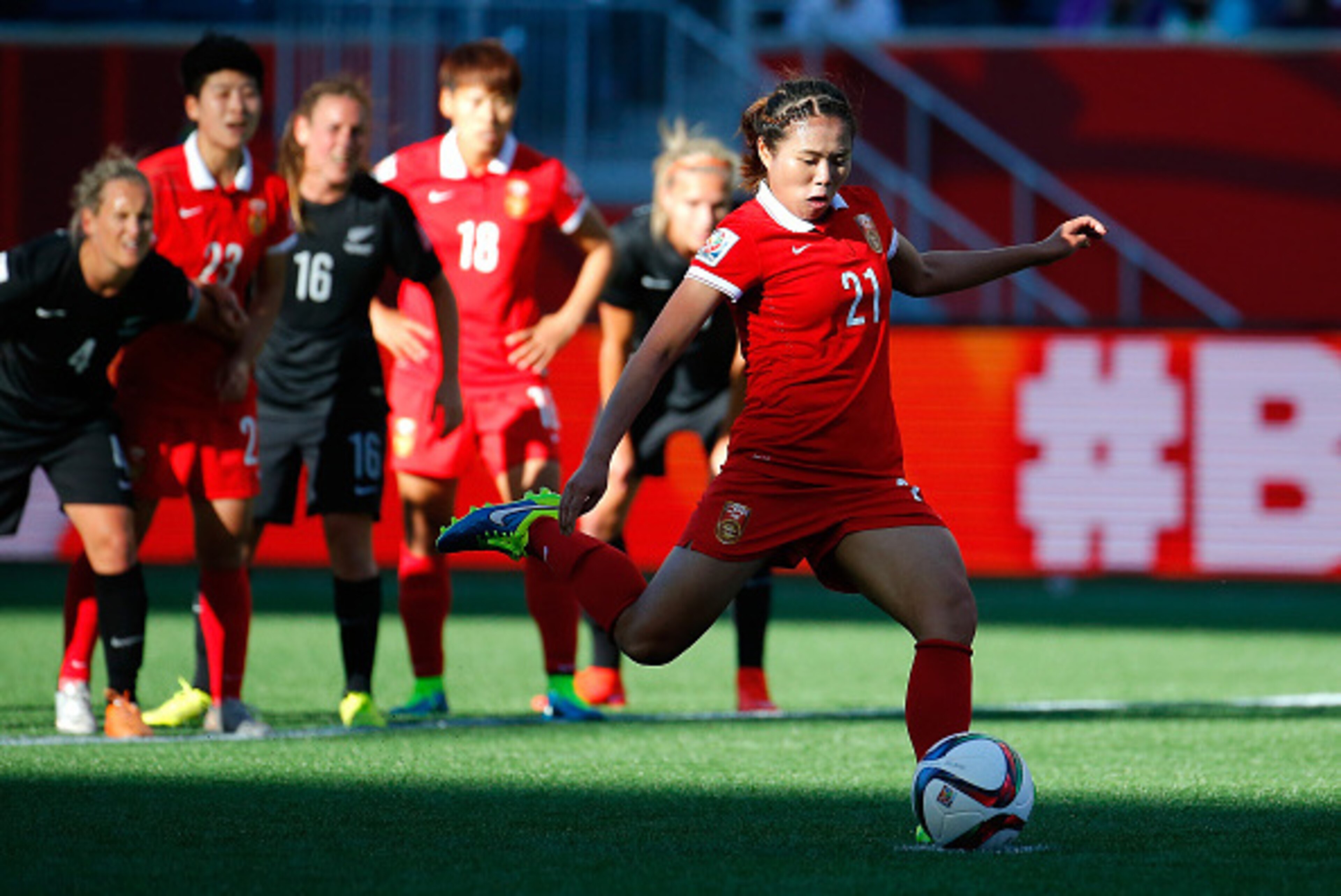 WINNIPEG, MB - JUNE 15:  Wang Lisi #21 of China PR scores their first goal on a penalty kick against New Zealand during the FIFA Women's World Cup Canada 2015 Group A match between China PR and New Zealand at Winnipeg Stadium on June 15, 2015 in Winnipeg,