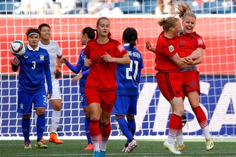 WINNIPEG, MB - JUNE 15:  Lena Petermann #19 of Germany celebrates her second goal against Thailand with Melanie Behringer #7 during the FIFA Women's World Cup Canada 2015 match between Thailand and Germany at Winnipeg Stadium on June 15, 2015 in Winnipeg,