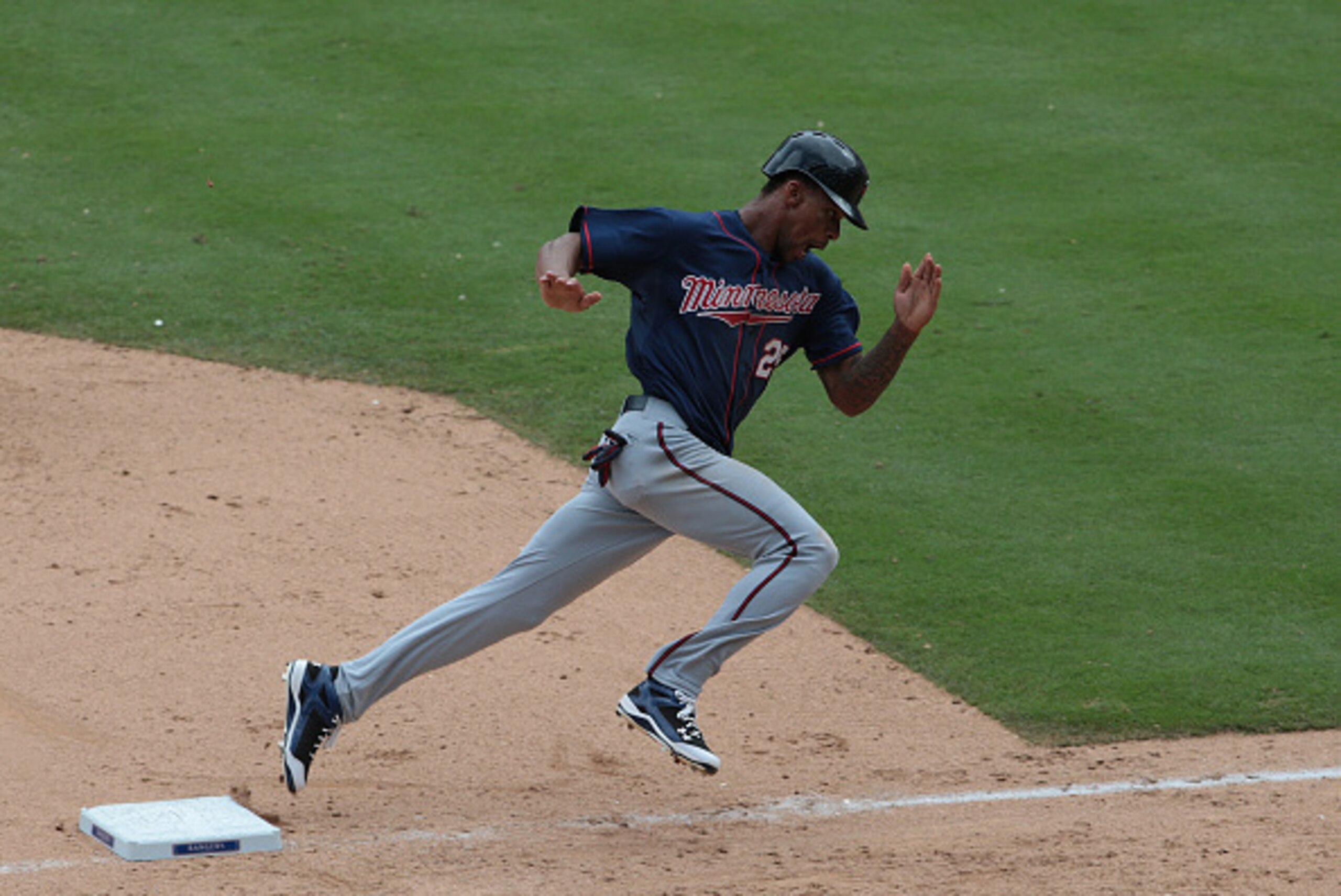 ARLINGTON, TX - AUGUST 25: Byron Buxton #25 of the Minnesota rounds third base to score on a double hit by  Eddie Rosario #20 in the ninth inning taking the lead against the Texas Rangers at Global Life Park on June 14, 2015 in Arlington, Texas. (Photo by
