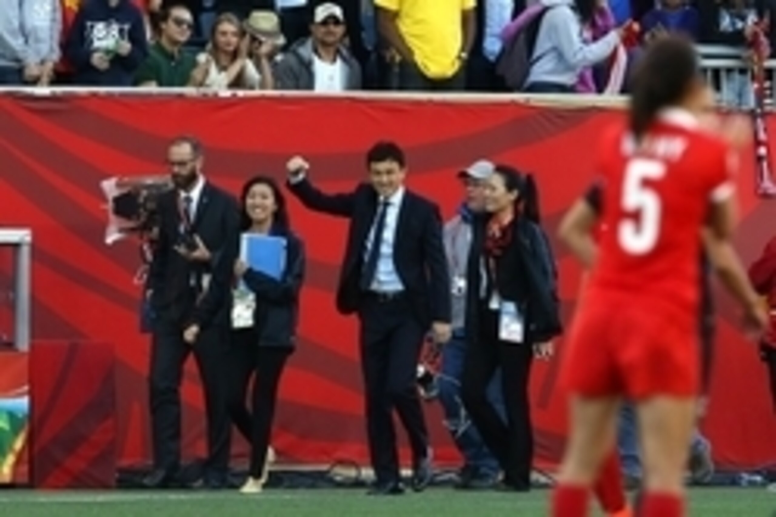 Jun 15, 2015; Winnipeg, Manitoba, CAN; China PR head coach Hao Wei pumps  his fist as the second half of a Group A soccer match against New Zealand ends in the 2015 FIFA women's World Cup at Winnipeg Stadium. The game ended in a 2-2 tie. Mandatory Credit: