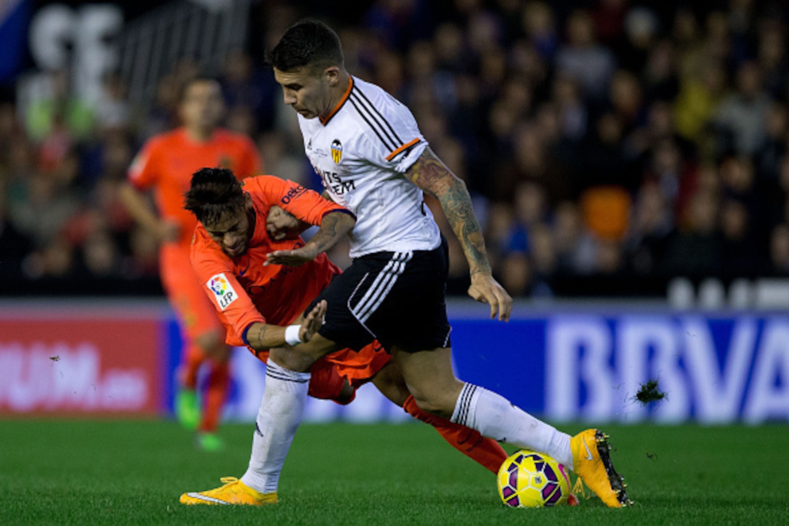 VALENCIA, SPAIN - NOVEMBER 30:  Neymar JR. (L) of FC Barcelona is tackled by Nicolas Otamendi (R) of Valencia CF  during the La Liga match between Valencia CF and FC Barcelona at Estadi de Mestalla on November 30, 2014 in Valencia, Spain.  (Photo by Gonza