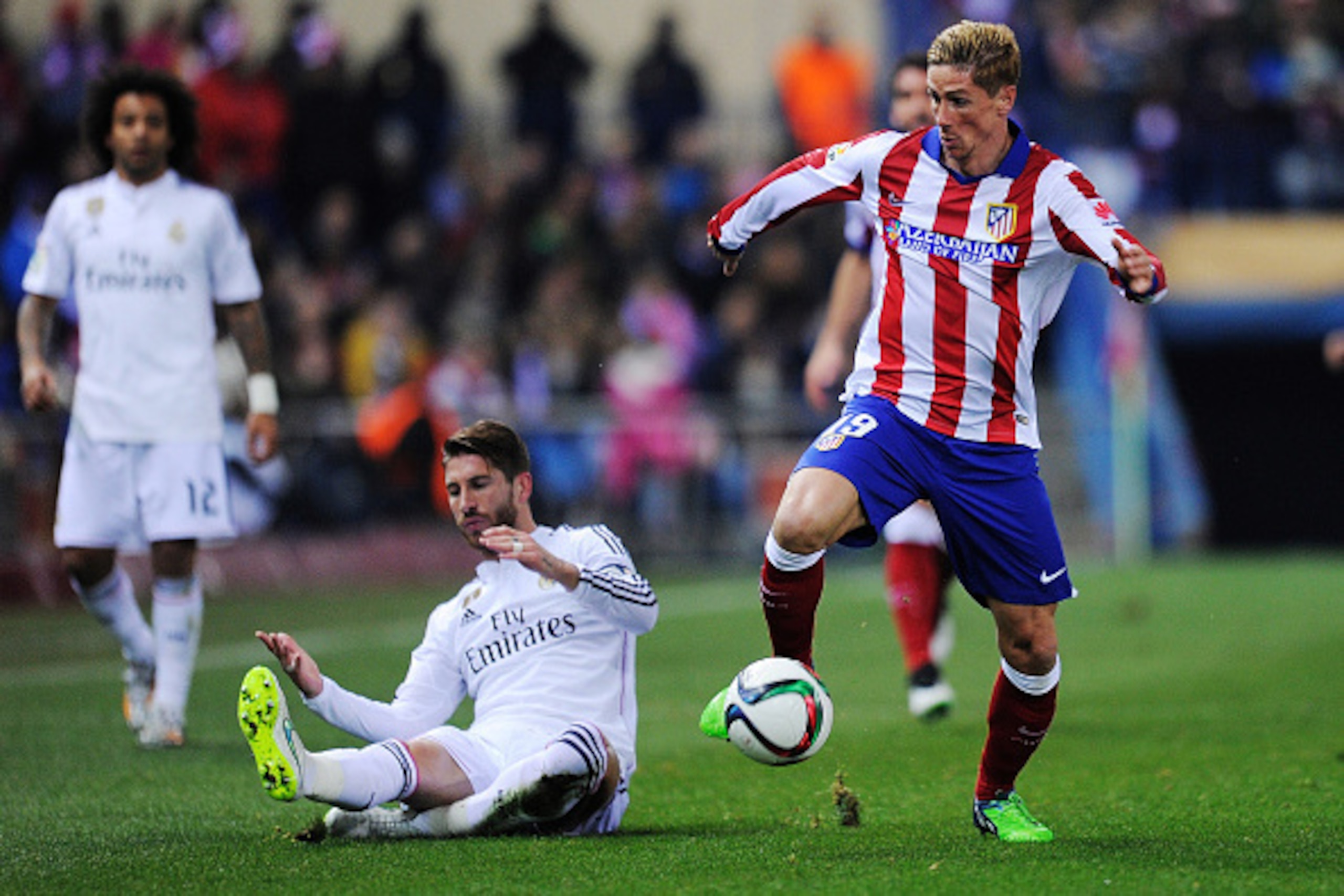 MADRID, SPAIN - JANUARY 07:  Fernando Torres of Club Atletico de Madrid gets past Sergio Ramos of Real Madrid
during the Copa del Rey Round of 16, First Leg match between Club Atletico de Madrid and Real Madrid at Vicente Calderon Stadium on January 7, 20