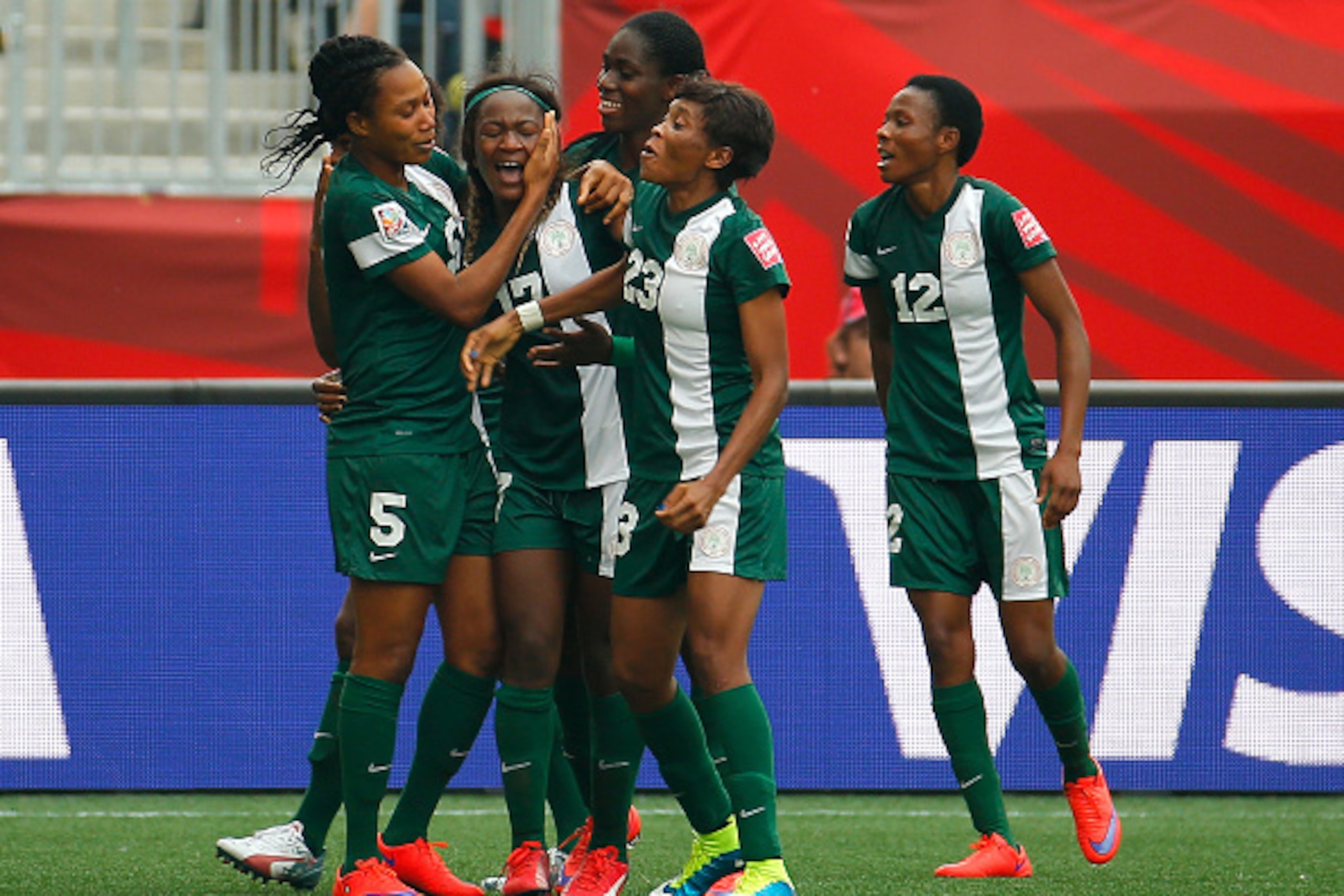 WINNIPEG, MB - JUNE 08:  Francisca Ordega #17 of Nigeria celebrates her game-tying goal against Sweden with Onome Ebi #5, Asisat Oshoala #8 and Ngozi Ebere #23 during the FIFA Women's World Cup Canada 2015 Group D match between Sweden and Nigeria at Winni