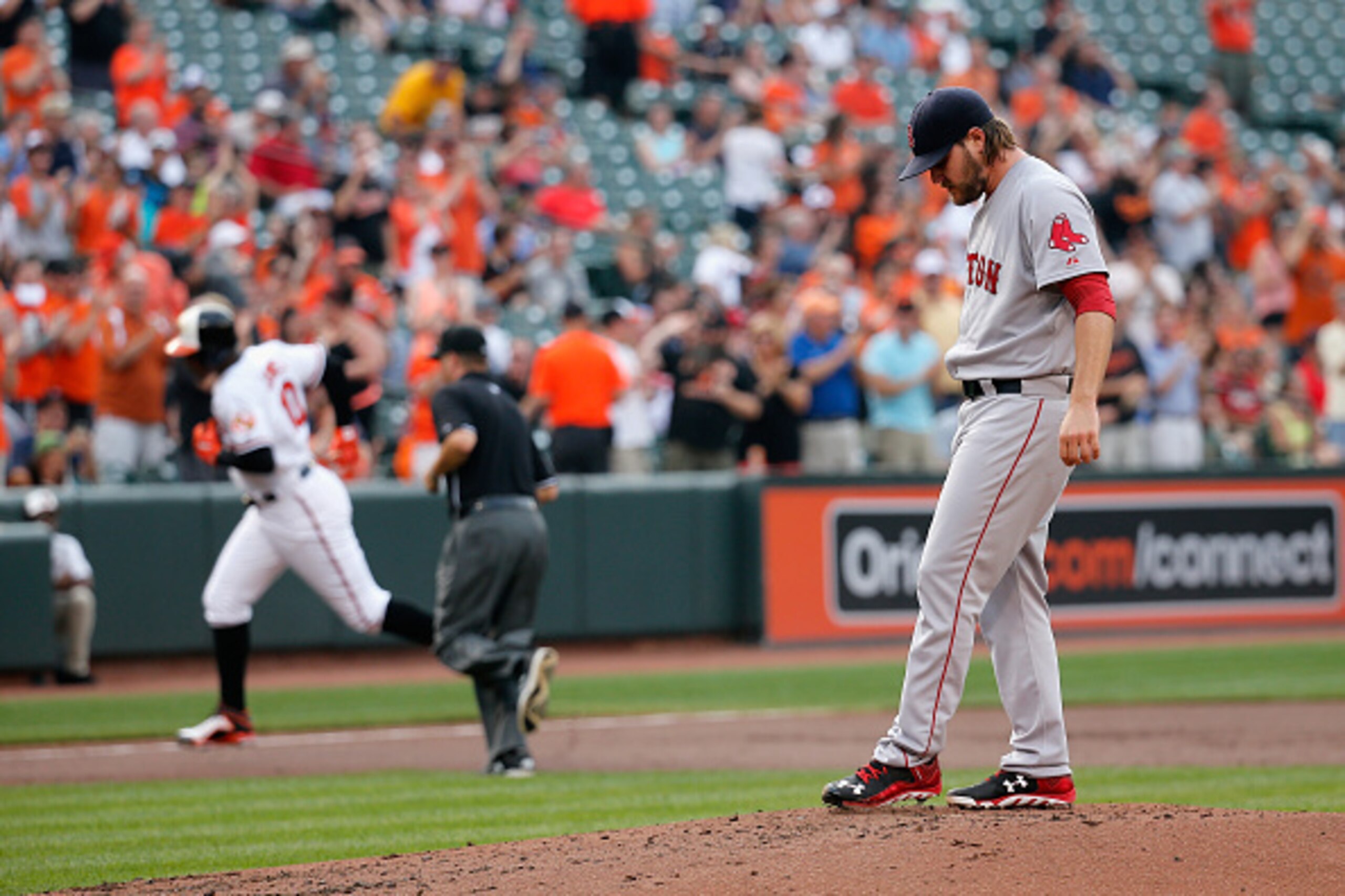 BALTIMORE, MD - JUNE 11: Adam Jones #10 of the Baltimore Orioles rounds the bases after hitting a solo home run off of pitcher Wade Miley #20 of the Boston Red Sox in the first inning at Oriole Park at Camden Yards on June 11, 2015 in Baltimore, Maryland.