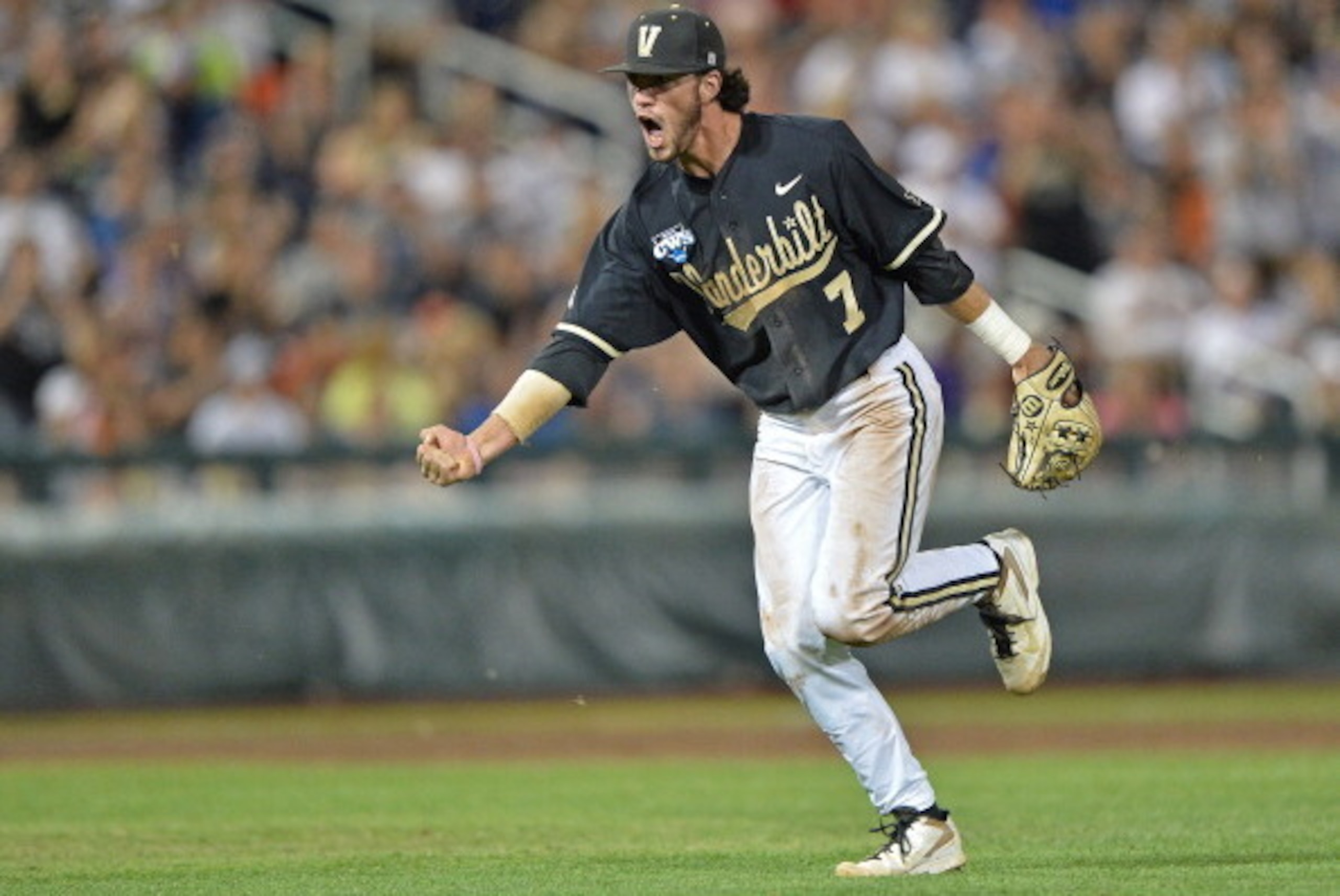 Omaha, NE - JUNE 25: Second basemen Dansby Swanson #7 of the Vanderbilt Commodores celebrates after recording the final out of the eighth inning against the Virginia Cavaliers during game three of the College World Series Championship Series on June 25, Omaha, NE - JUNE 25: Second basemen Dansby Swanson #7 of the Vanderbilt Commodores celebrates after recording the final out of the eighth inning against the Virginia Cavaliers during game three of the College World Series Championship Series on June 25,