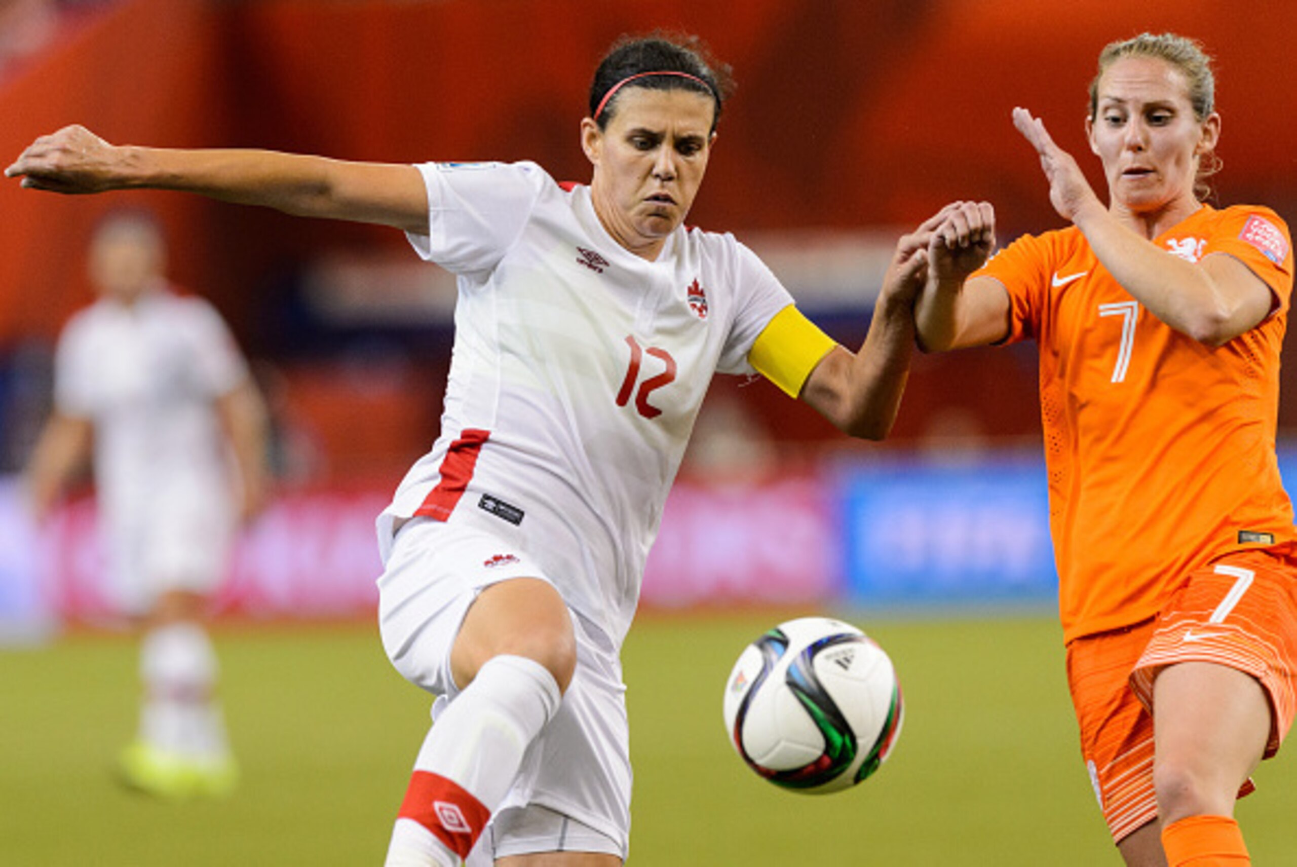 MONTREAL, QC - JUNE 15: Christine Sinclair #12 of Canada and Manon Melis #7 of the Netherlands battle for the ball during the 2015 FIFA Women's World Cup Group A match at Olympic Stadium on June 15, 2015 in Montreal, Quebec, Canada. Final score between MONTREAL, QC - JUNE 15: Christine Sinclair #12 of Canada and Manon Melis #7 of the Netherlands battle for the ball during the 2015 FIFA Women's World Cup Group A match at Olympic Stadium on June 15, 2015 in Montreal, Quebec, Canada. Final score between