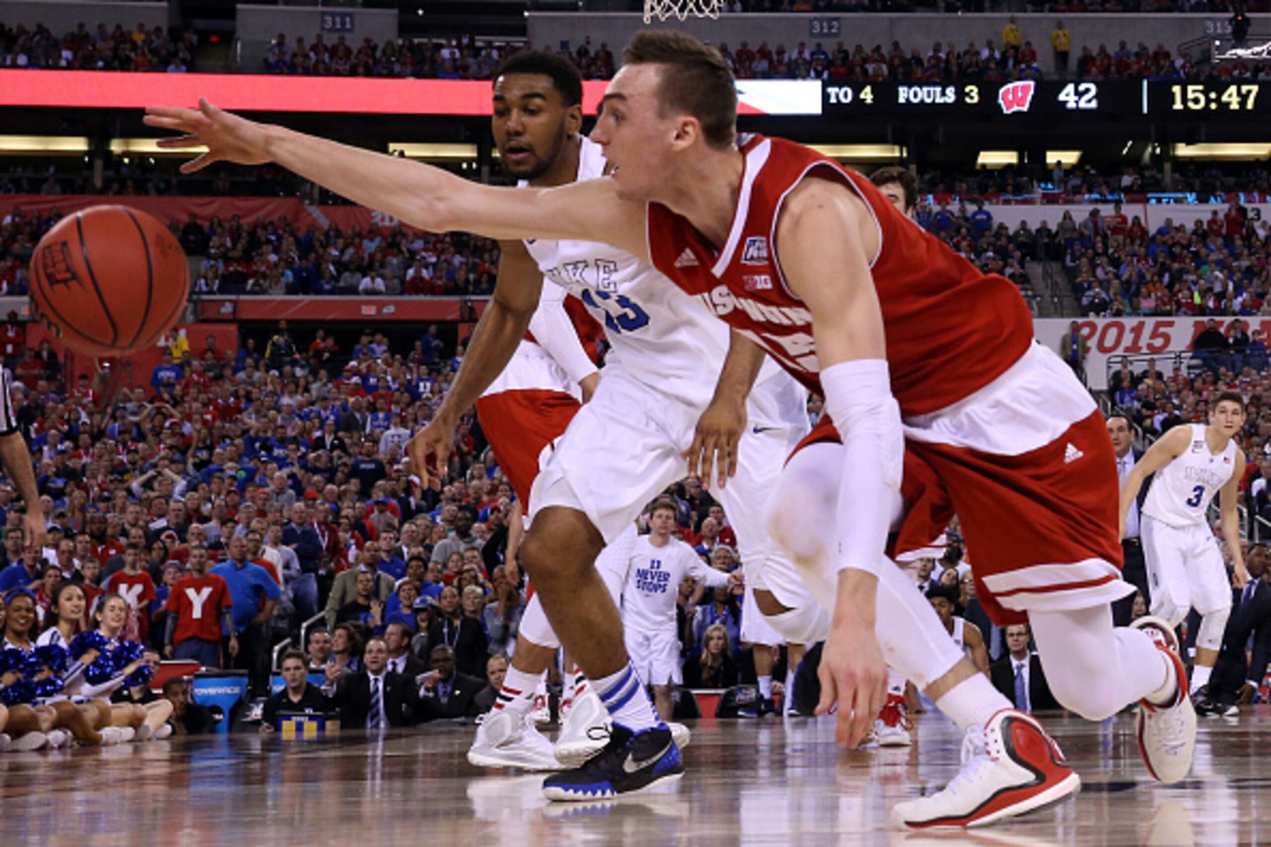 INDIANAPOLIS, IN - APRIL 06: Sam Dekker #15 of the Wisconsin Badgers goes for a loose ball against Matt Jones #13 of the Duke Blue Devils in the second half during the NCAA Men's Final Four National Championship at Lucas Oil Stadium on April 6, 2015 in In