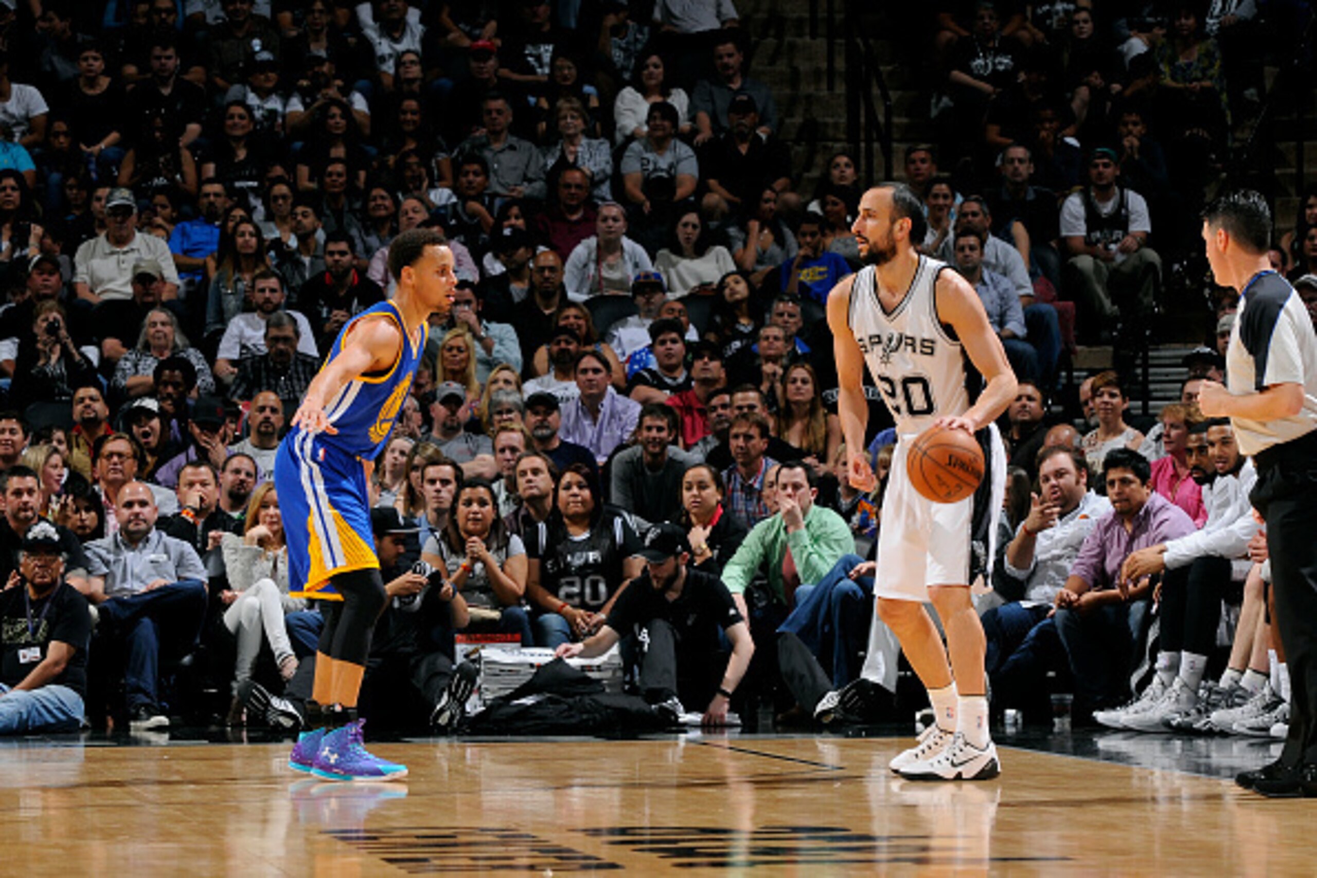 SAN ANTONIO, TX - APRIL 5: Manu Ginobili #20 of the San Antonio Spurs handles the ball against Stephen Curry #30 of the Golden State Warriors on April 5, 2015 at the AT&T Center in San Antonio, Texas. NOTE TO USER: User expressly acknowledges and agrees t