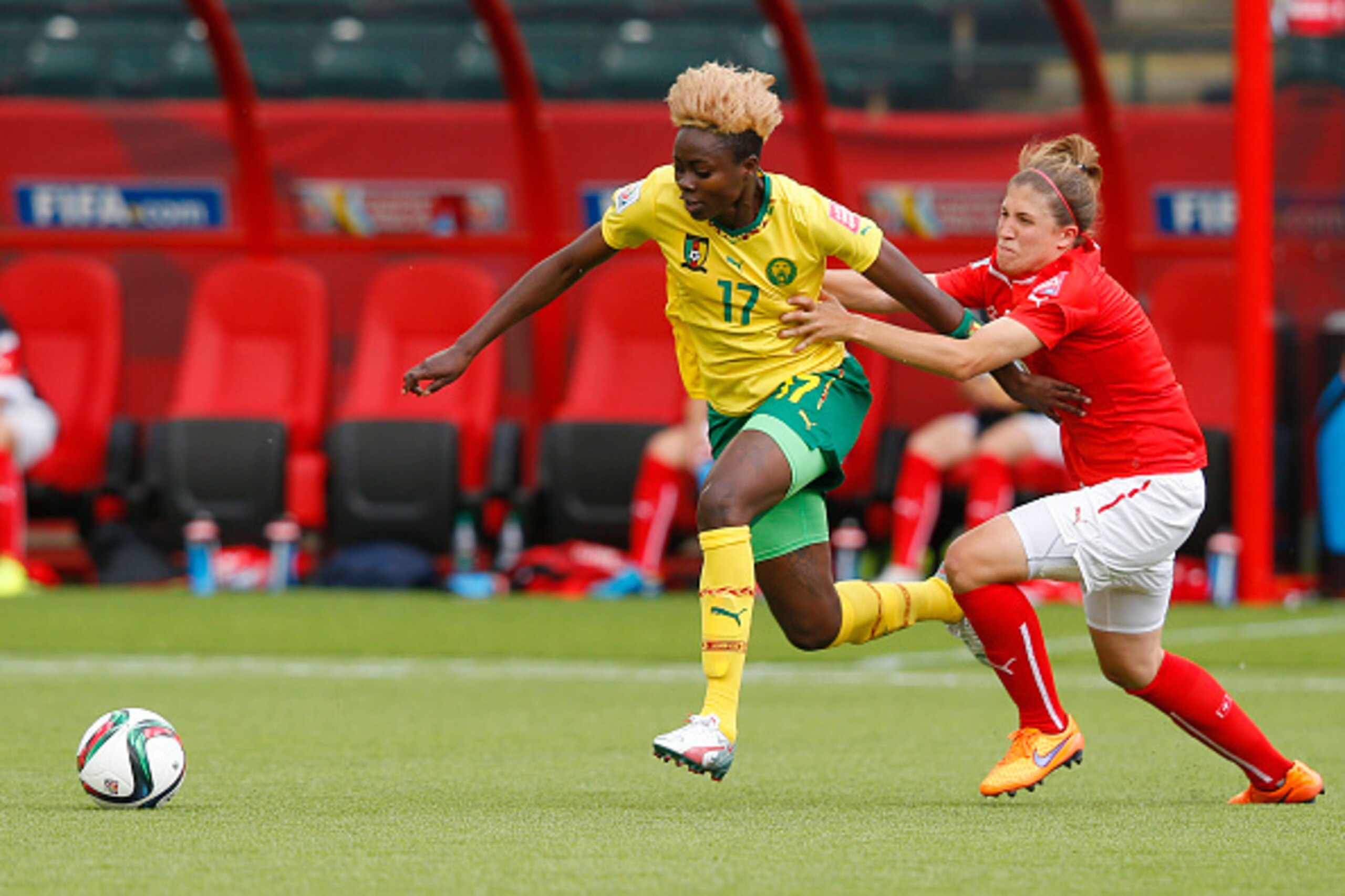 EDMONTON, AB - JUNE 16: Selina Kuster #6 of Switzerland tries to stop Gaelle Enganamouit #17 of Cameroon during the FIFA Women's World Cup Canada Group C match between Switzerland and Cameroon at Commonwealth Stadium on June 16, 2015 in Edmonton, Alberta,