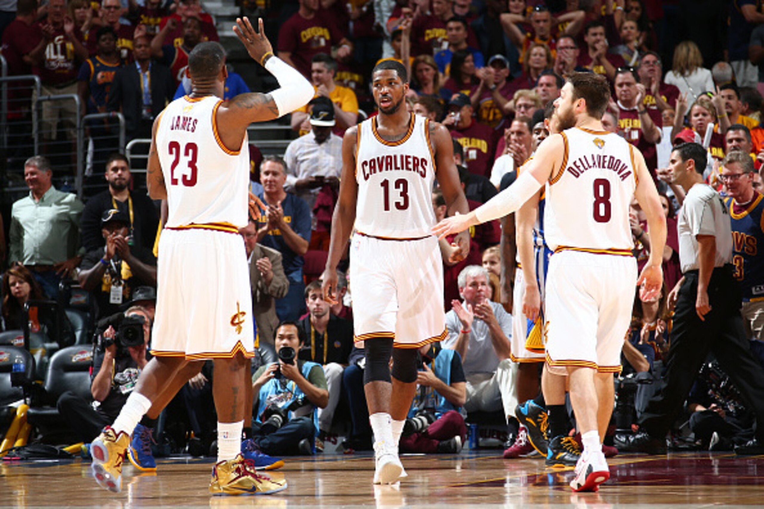 CLEVELAND, OH - JUNE 16:  Teammates LeBron James #23, Tristan Thompson #13, and Matthew Dellavedova #8 of the Cleveland Cavaliers high-five during Game Six of the 2015 NBA Finals at The Quicken Loans Arena on June 16, 2015 in Cleveland, Ohio. NOTE TO USER