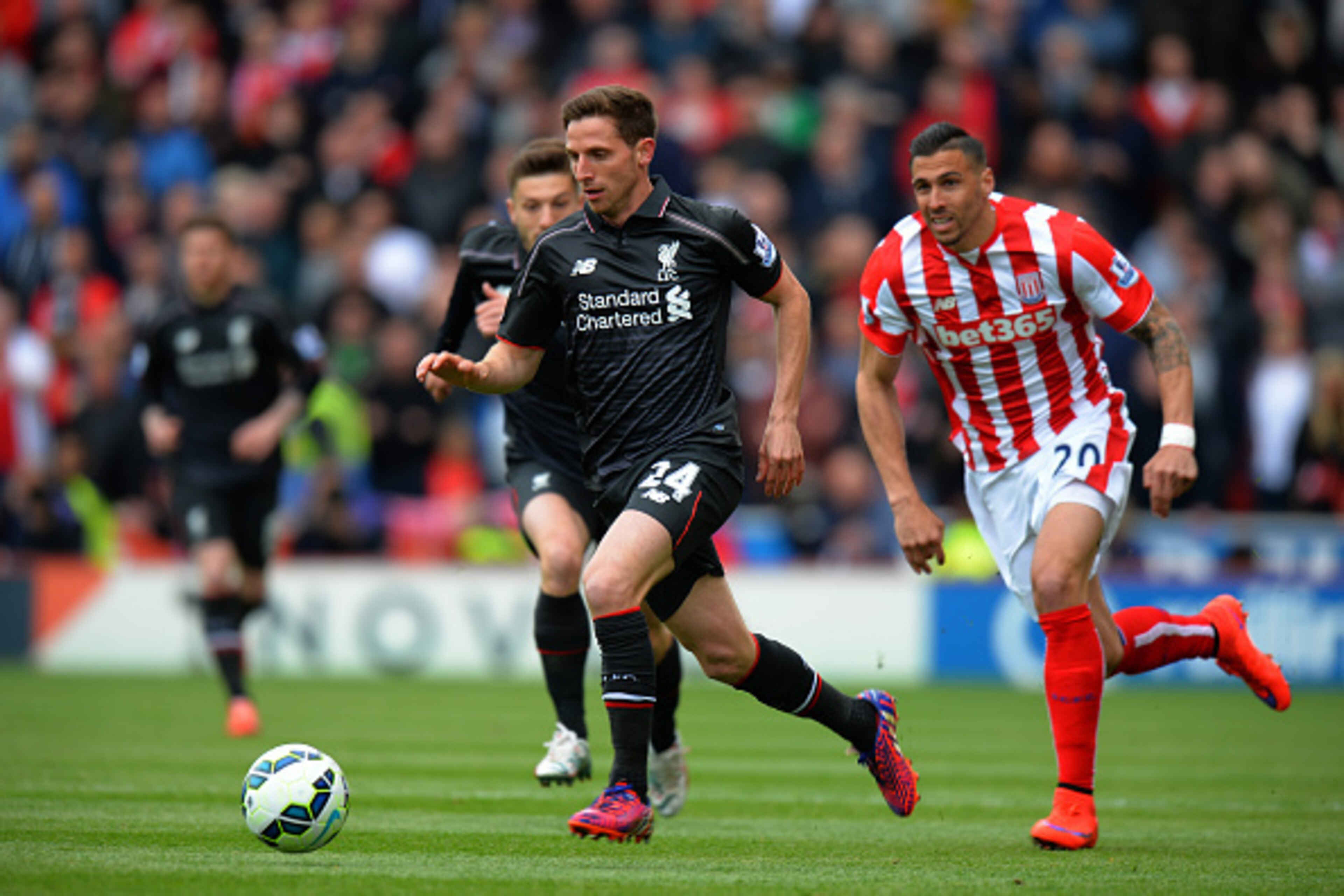 STOKE ON TRENT, ENGLAND - MAY 24:  Joe Allen of Liverpool gets away from Geoff Cameron of Stkoe City during the Barclays Premier League match between Stoke City and Liverpool at Britannia Stadium on May 24, 2015 in Stoke on Trent, England.  (Photo by Tony
