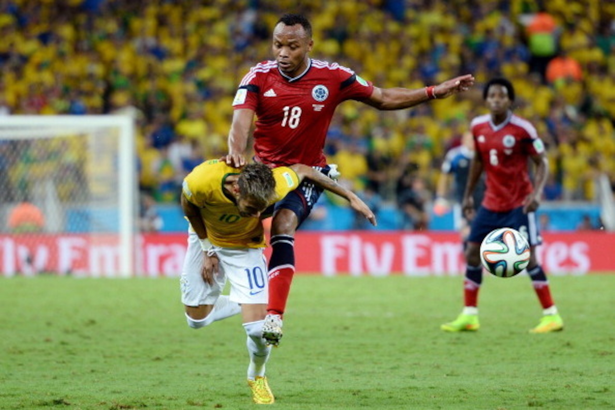 FORTALEZA, BRAZIL - JULY 04: Neymar of Brazil is challenged by Juan Camilo Zuniga of Colombia during the 2014 FIFA World Cup Brazil Quarter Final match between Brazil and Colombia at Castelao on July 4, 2014 in Fortaleza, Brazil.  This tackle resulted in 