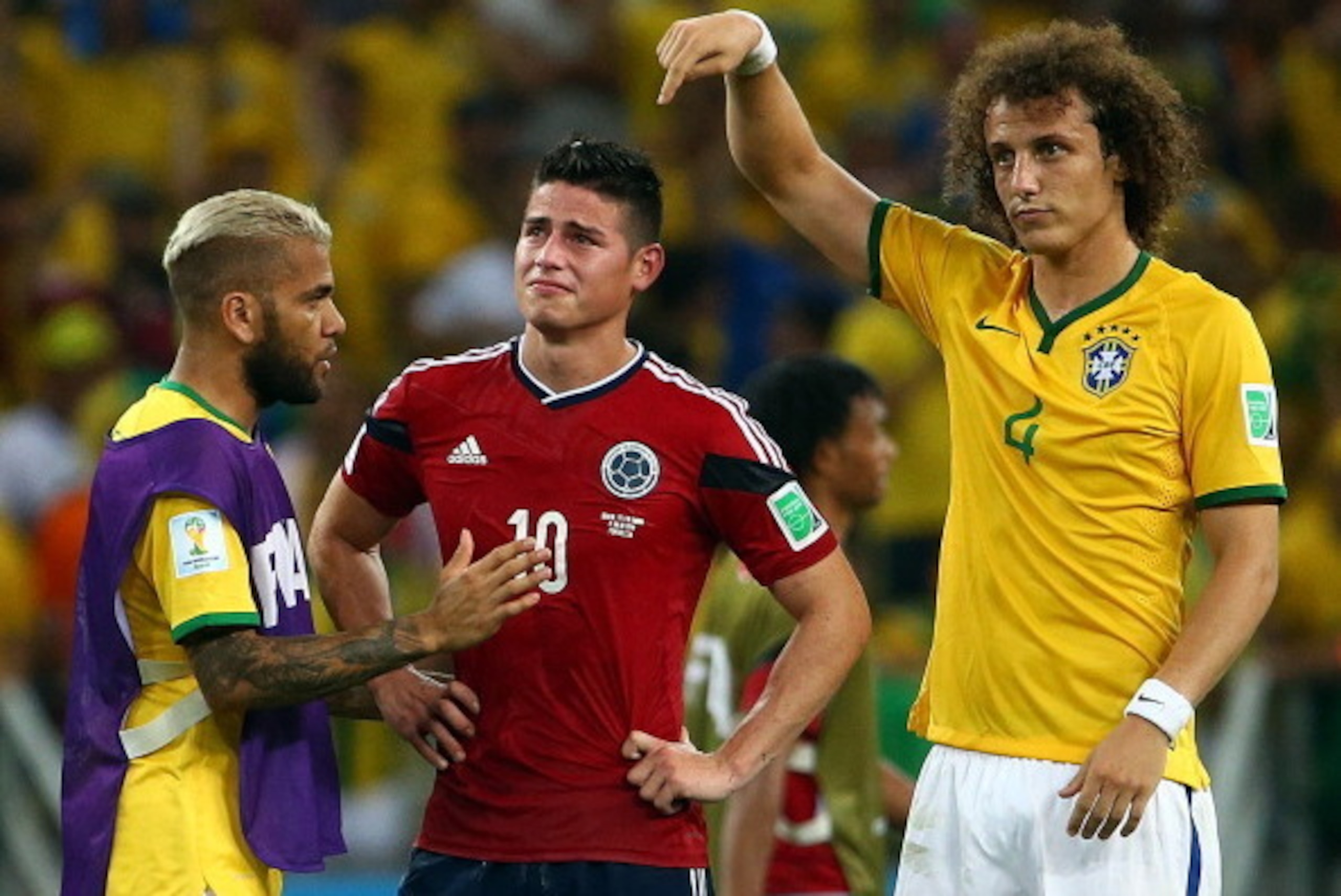 FORTALEZA, BRAZIL - JULY 04:  Dani Alves (L) and David Luiz of Brazil console James Rodriguez of Colombia after Brazil's 2-1 win during the 2014 FIFA World Cup Brazil Quarter Final match between Brazil and Colombia at Castelao on July 4, 2014 in Fortaleza