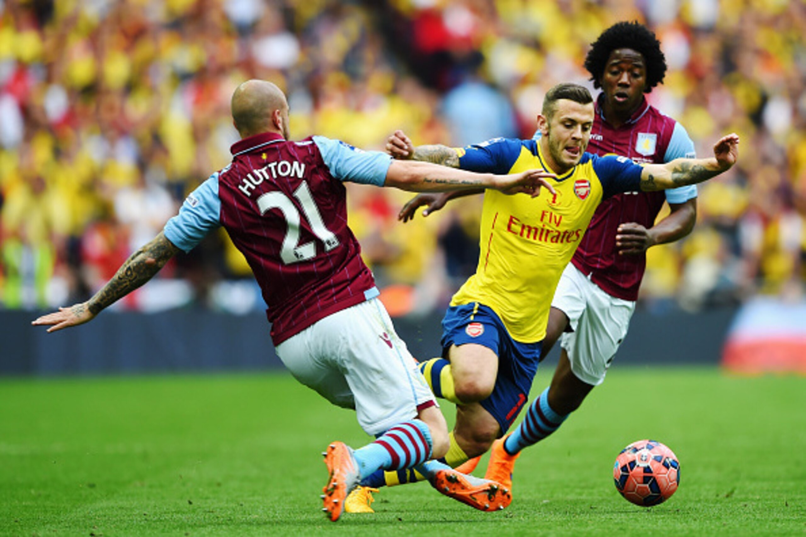 LONDON, ENGLAND - MAY 30: Jack Wilshere of Arsenal takes on Alan Hutton and Carlos Sanchez of Aston Villa during the FA Cup Final between Aston Villa and Arsenal at Wembley Stadium on May 30, 2015 in London, England. (Photo by Shaun Botterill/Getty Imag LONDON, ENGLAND - MAY 30: Jack Wilshere of Arsenal takes on Alan Hutton and Carlos Sanchez of Aston Villa during the FA Cup Final between Aston Villa and Arsenal at Wembley Stadium on May 30, 2015 in London, England. (Photo by Shaun Botterill/Getty Imag