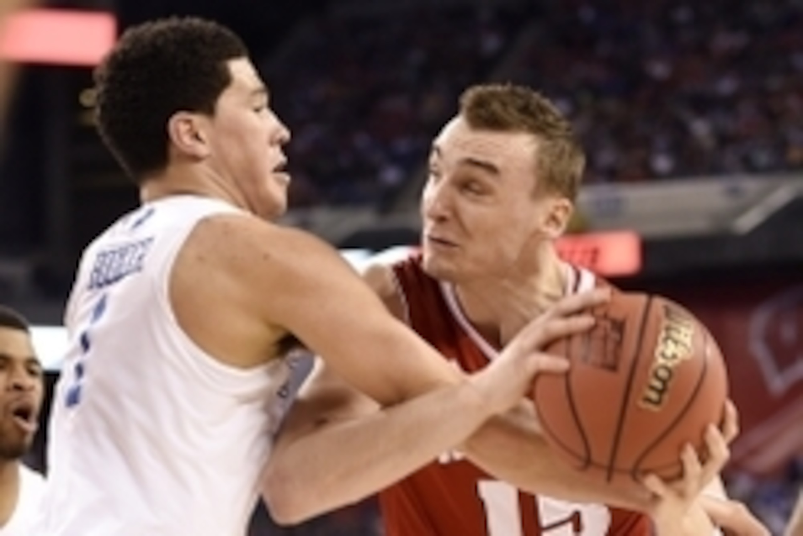 Apr 4, 2015; Indianapolis, IN, USA; Wisconsin Badgers forward Sam Dekker (15) is defended by Kentucky Wildcats guard Devin Booker (1) in the second half of the 2015 NCAA Men's Division I Championship semi-final game at Lucas Oil Stadium. Mandatory Credit: