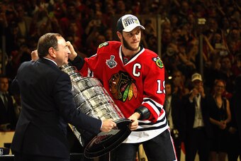CHICAGO, IL - JUNE 15:  Jonathan Toews #19 of the Chicago Blackhawks is presented the Stanley Cup from NHL Commissioner Gary Bettman after the Blachawks defeated the Tampa Bay Lightning 2-0 in Game Six of the 2015 NHL Stanley Cup Final at the United Cente