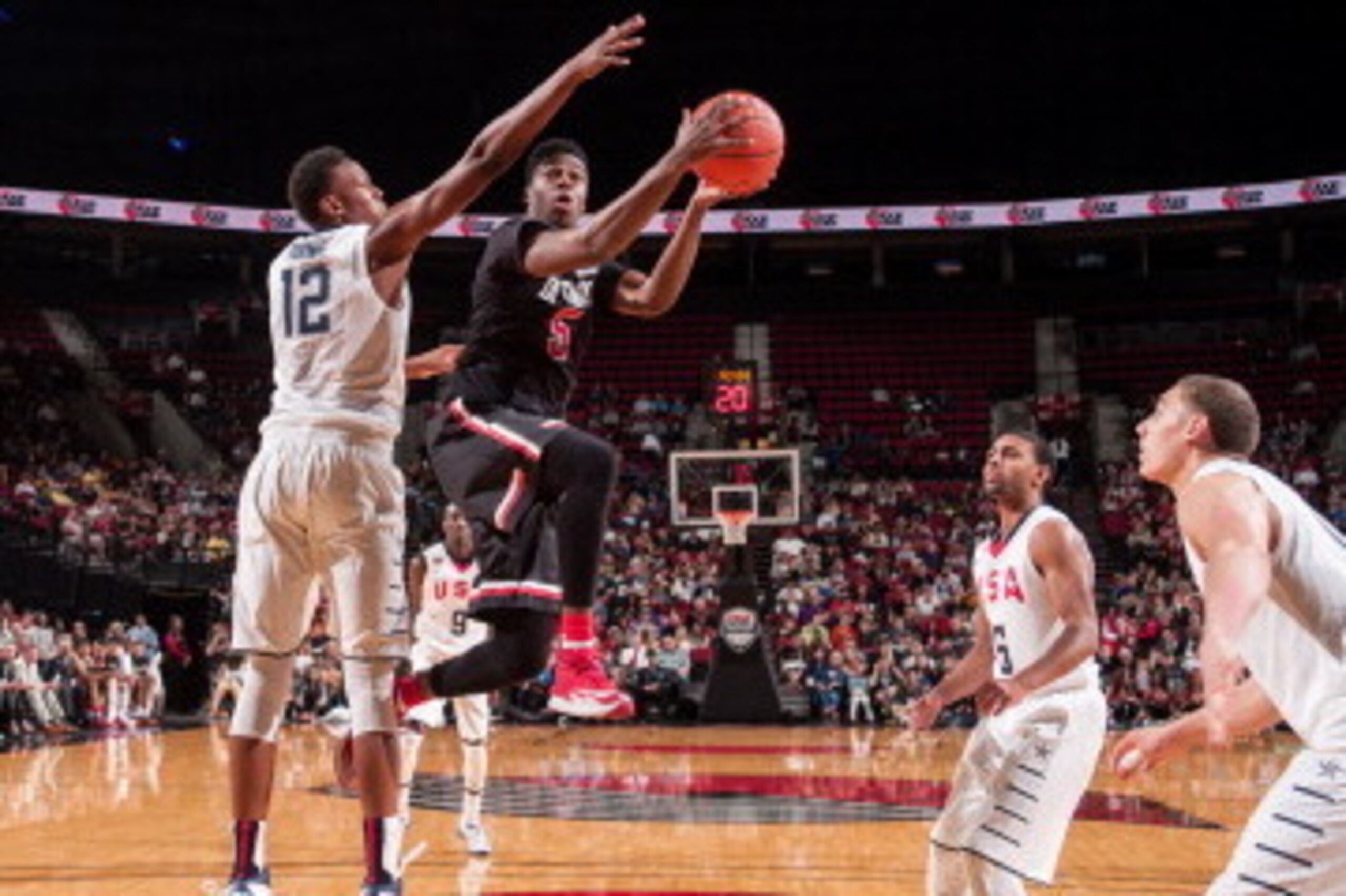 PORTLAND, OR - APRIL 12:  Emmanuel Mudiay #5 of the World Team drives to the basket during the game against Team USA on April 12, 2014 at the Moda Center Arena in Portland, Oregon. NOTE TO USER: User expressly acknowledges and agrees that, by downloading 