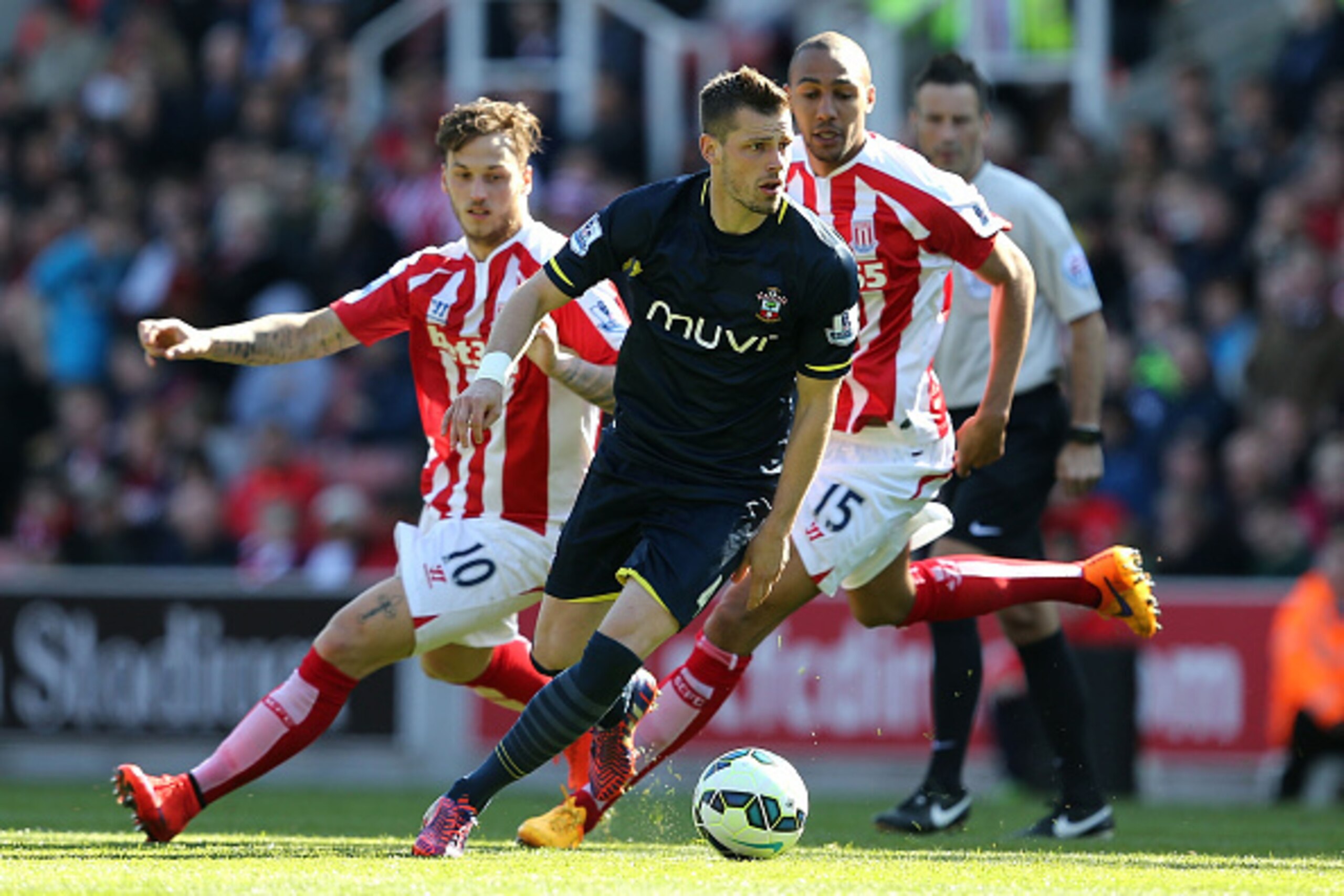 STOKE ON TRENT, ENGLAND - APRIL 18:  Morgan Schneiderlin of Southampton competes with Marko Arnautovic and Steven Nzonzi of Stoke during the Barclays Premier League match between Stoke City and Southampton at the Britannia Stadium on April 18, 2015 in Sto