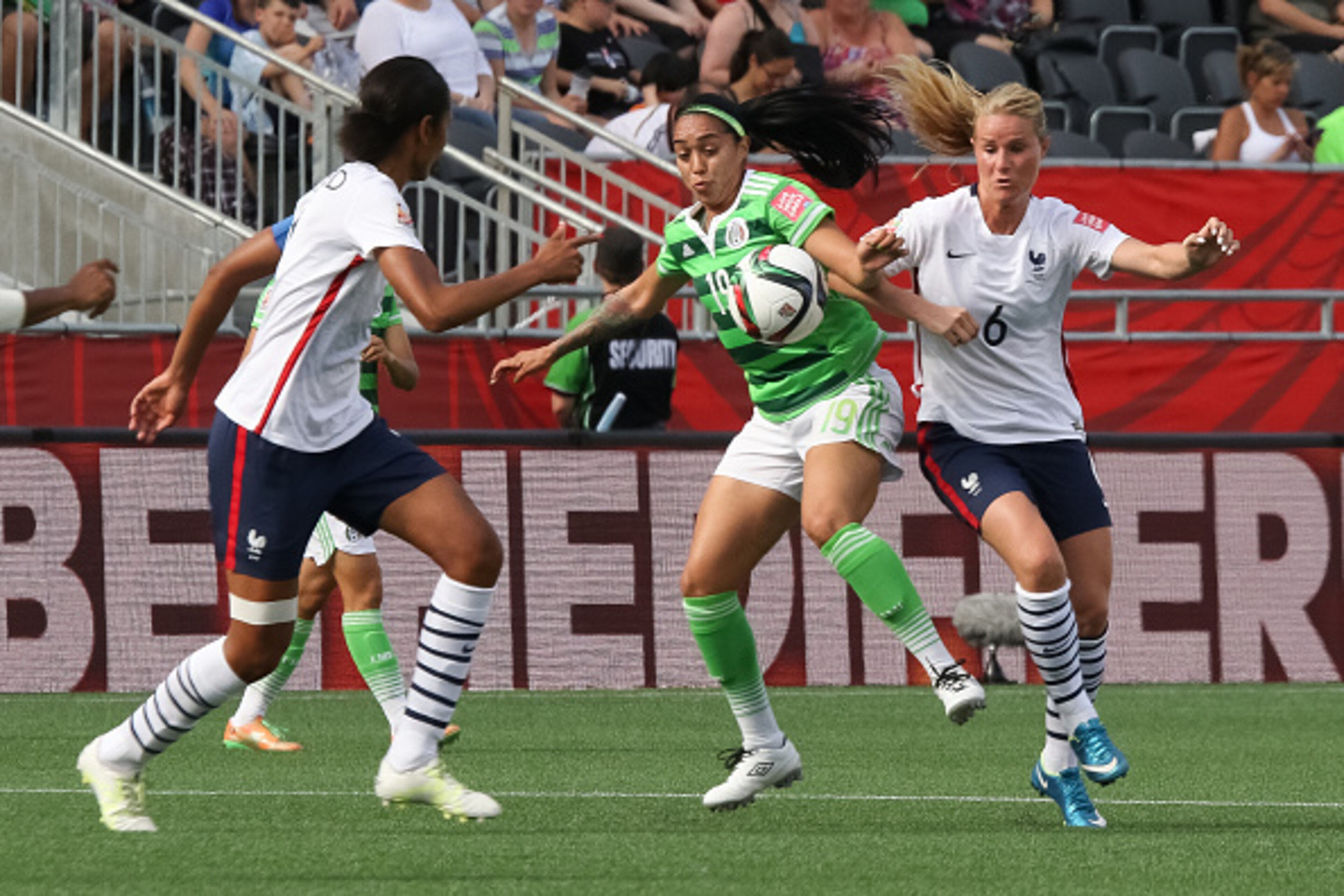 OTTAWA, ON - JUNE 17: Renae Cuellar #19 of Mexico battles for the ball against Amandine Henry #6 of France during the FIFA Women's World Cup Canada 2015 Group F match between Mexico and France at Lansdowne Stadium on June 17, 2015 in Ottawa, Canada.  (Pho