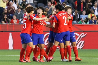 OTTAWA, ON - JUNE 17: Doyeon Kim #5, Hahnul Kwon #13, Eunmi Lee #2 and Younga Yoo #12 of Korea Republic celebrate their team's second goal during the FIFA Women's World Cup Canada 2015 Group E match between Korea Republic and Spain at Lansdowne Stadium on