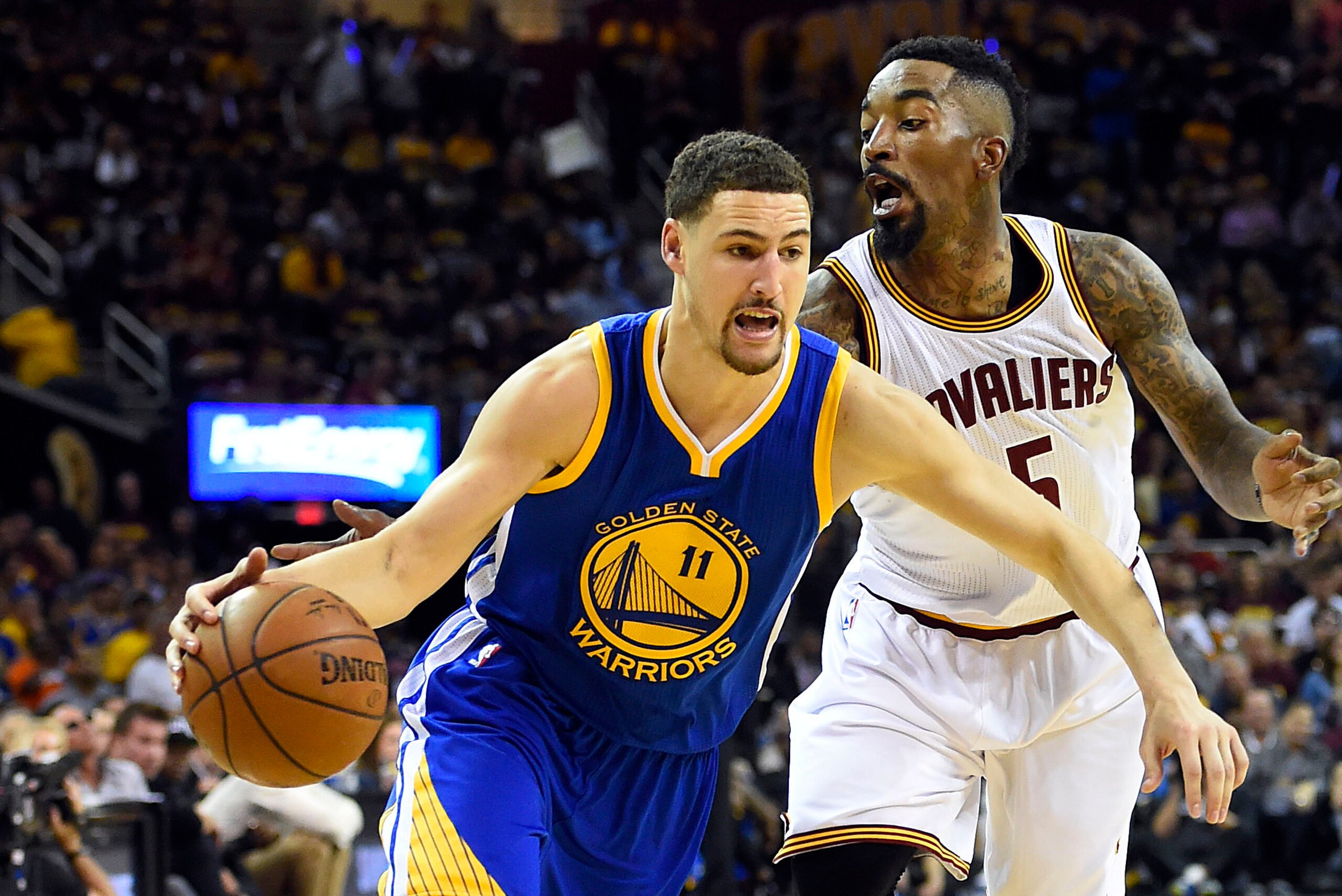 Jun 16, 2015; Cleveland, OH, USA; Golden State Warriors guard Klay Thompson (11) drives to the basket against Cleveland Cavaliers guard J.R. Smith (5) during the fourth quarter in game six of the NBA Finals at Quicken Loans Arena. Mandatory Credit: Bob Do