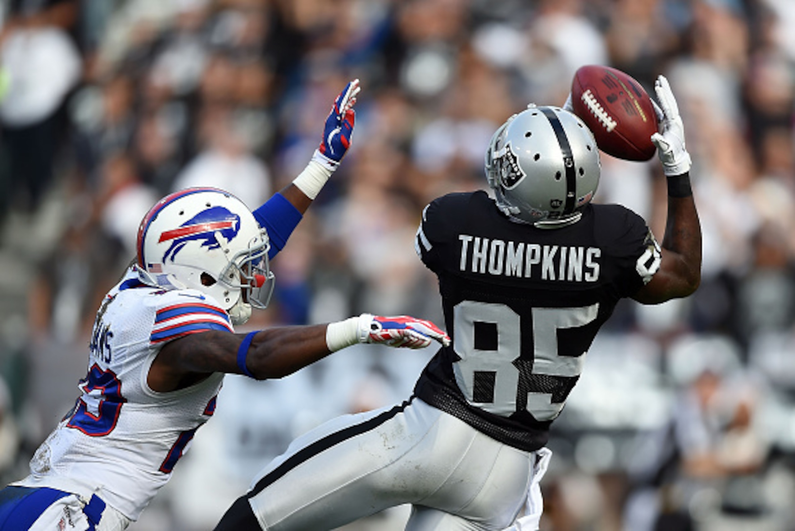 OAKLAND, CA - DECEMBER 21:  Kenbrell Thompkins #85 of the Oakland Raiders pulls in a pass in front of Aaron Williams #23 of the Buffalo Bills in the first half  at O.co Coliseum on December 21, 2014 in Oakland, California.  (Photo by Thearon W. Henderson/