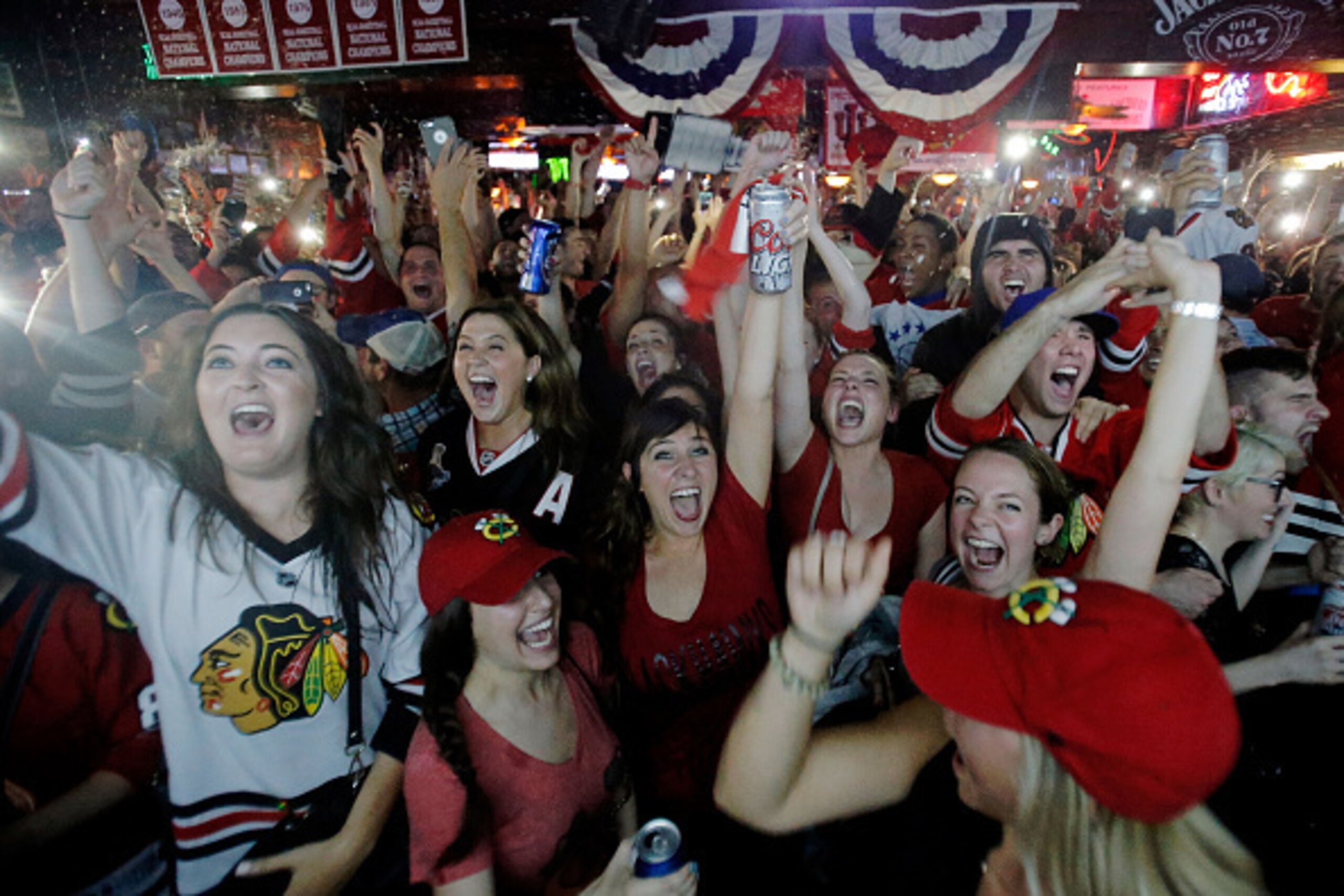 CHICAGO, IL - JUNE 15:  Fans celebrate the Chicago Blackhawks winning the 2015 Stanley Cup at Sluggers World Class Sports Bar on June 15, 2015 in Chicago, Illinois. The Blackhawks beat the Lightning 2 - 0 to win the Stanley Cup. (Photo by Jon Durr/Getty I