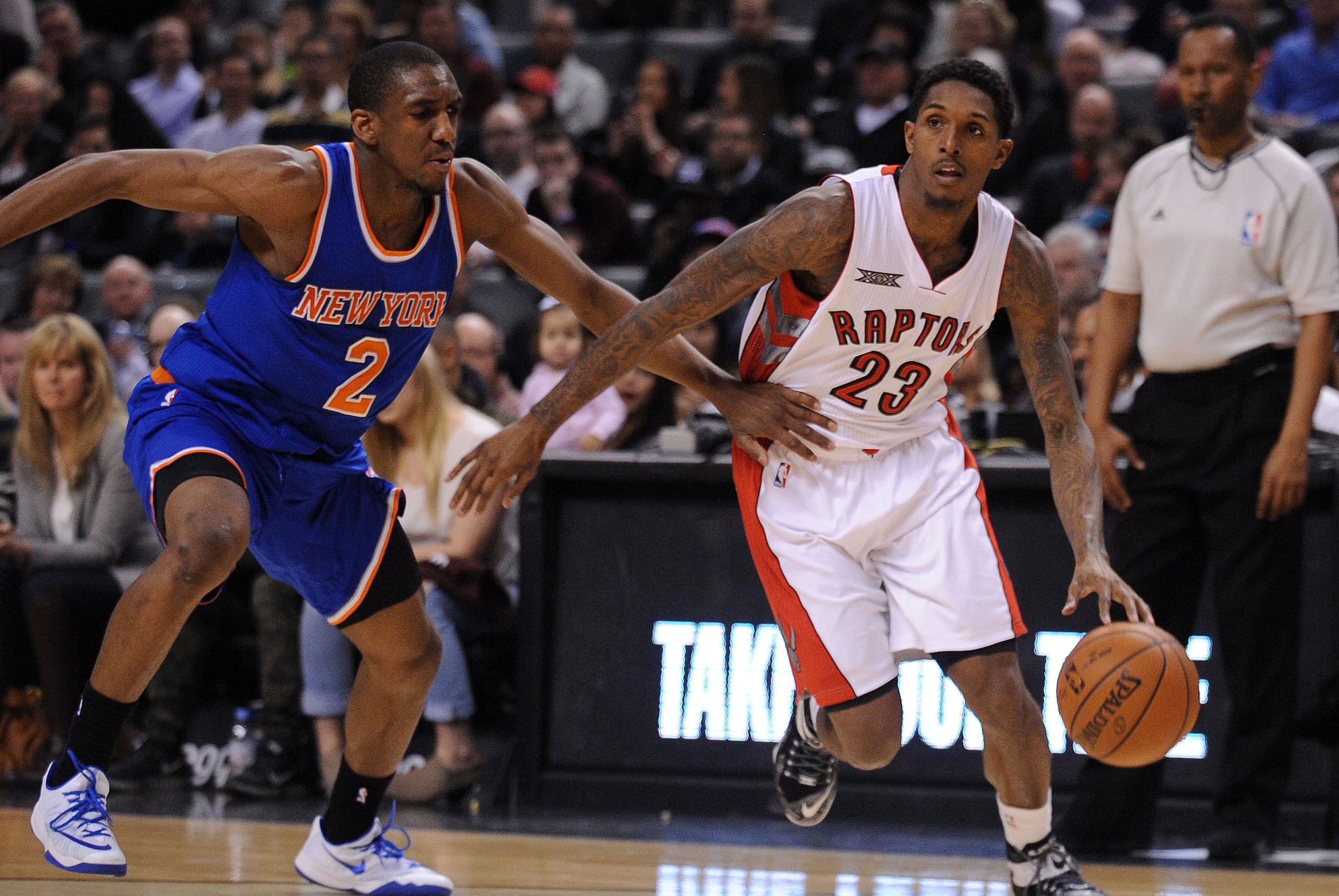 Mar 22, 2015; Toronto, Ontario, CAN;  Toronto Raptors guard Lou Williams (23) dribbles past New York Knicks guard Landston Galloway (2) in the third quarter at Air Canada Centre. Raptors won 106 - 89. Mandatory Credit: Peter Llewellyn-USA TODAY Sports