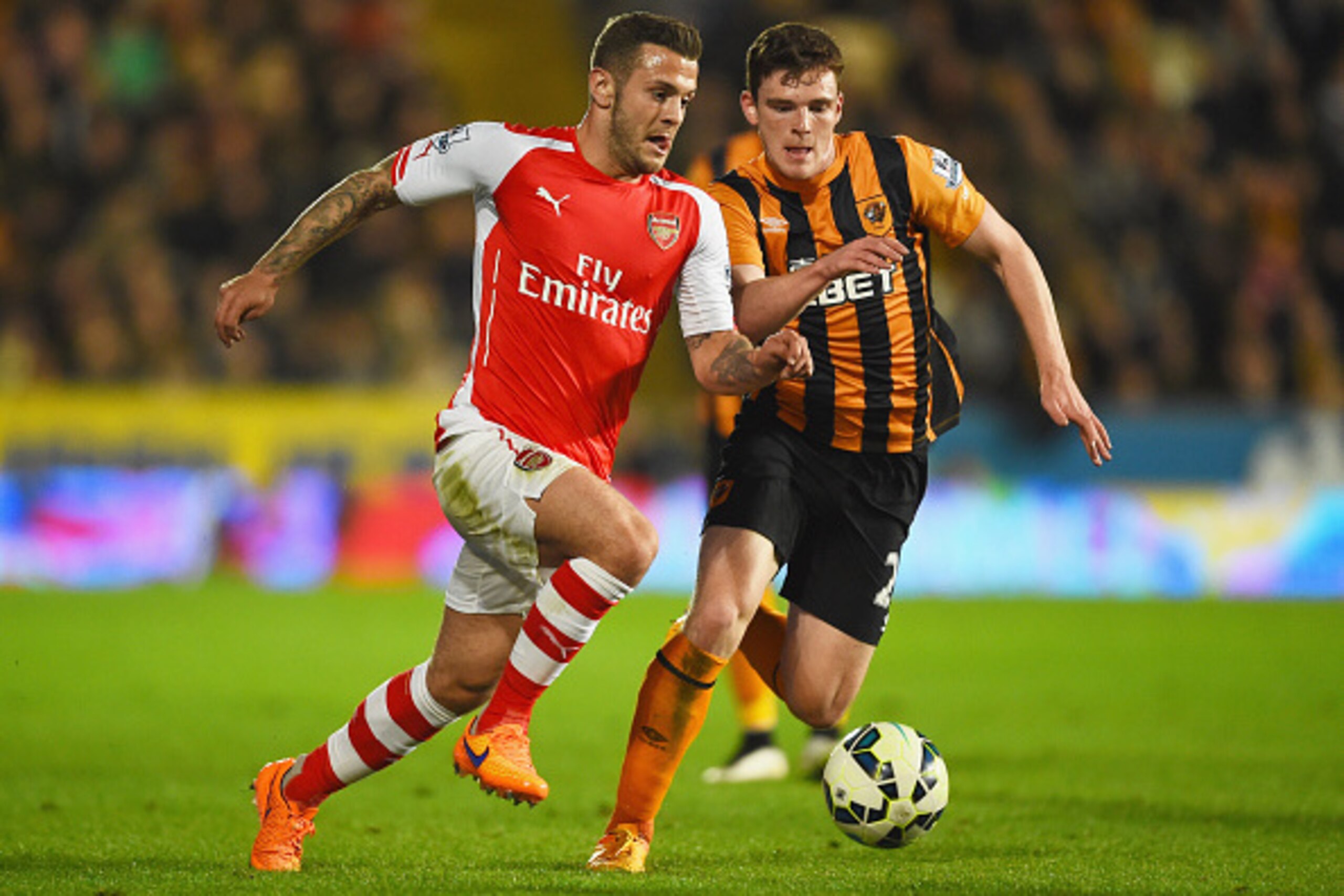 HULL, ENGLAND - MAY 04:  Jack Wilshere of Arsenal takes on Andrew Robertson of Hull City during the Barclays Premier League match between Hull City and Arsenal at KC Stadium on May 4, 2015 in Hull, England.  (Photo by Laurence Griffiths/Getty Images)
