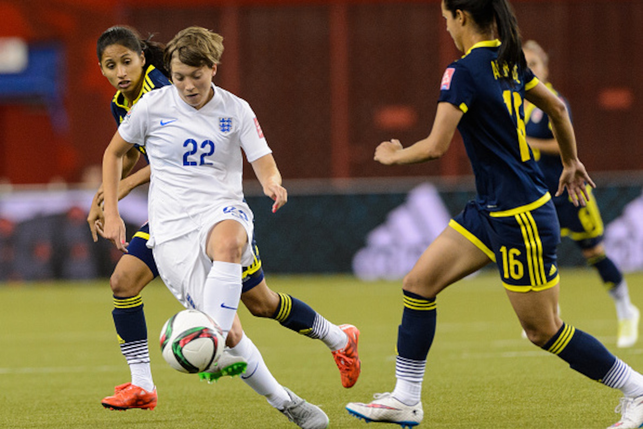 MONTREAL, QC - JUNE 17:  Fran Kirby #22 of England tries to move the ball past Lady Andrade #16 of Colombia during the 2015 FIFA Women's World Cup Group F match at Olympic Stadium on June 17, 2015 in Montreal, Quebec, Canada.  (Photo by Minas Panagiotakis