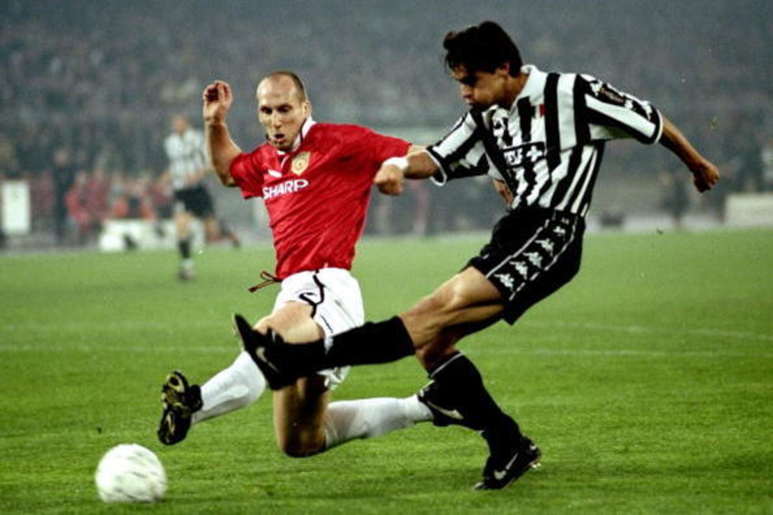 21 Apr 1999:  Filippo Inzaghi of Juventus (right) shoots past Manchester United defender Jaap Stam  to score the second goal during the UEFA Champions League semi-final second leg match at the Stadio delle Alpi in Turin, Italy. United won 3-2 on the night