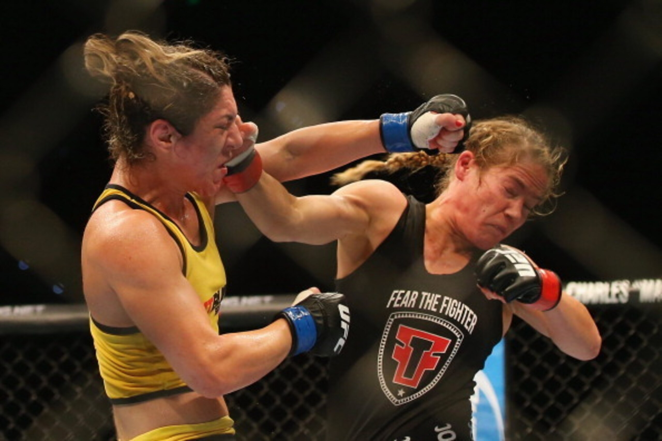 BRISBANE, AUSTRALIA - DECEMBER 07:  Bethe Correia of Brazil and Julie Kedzie of the USA exchange punches during their women's bantamweight fight during the UFC Fight Night event atat Brisbane Entertainment Centre on December 7, 2013 in Brisbane, Australia