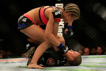 NEWARK, NJ - APRIL 18:  Felice Herrig (black top) and Paige VanZant (pink top) fight in their women's strawweight bout during the UFC Fight Night event at Prudential Center on April 18, 2015 in Newark, New Jersey.  (Photo by Alex Trautwig/Getty Images)