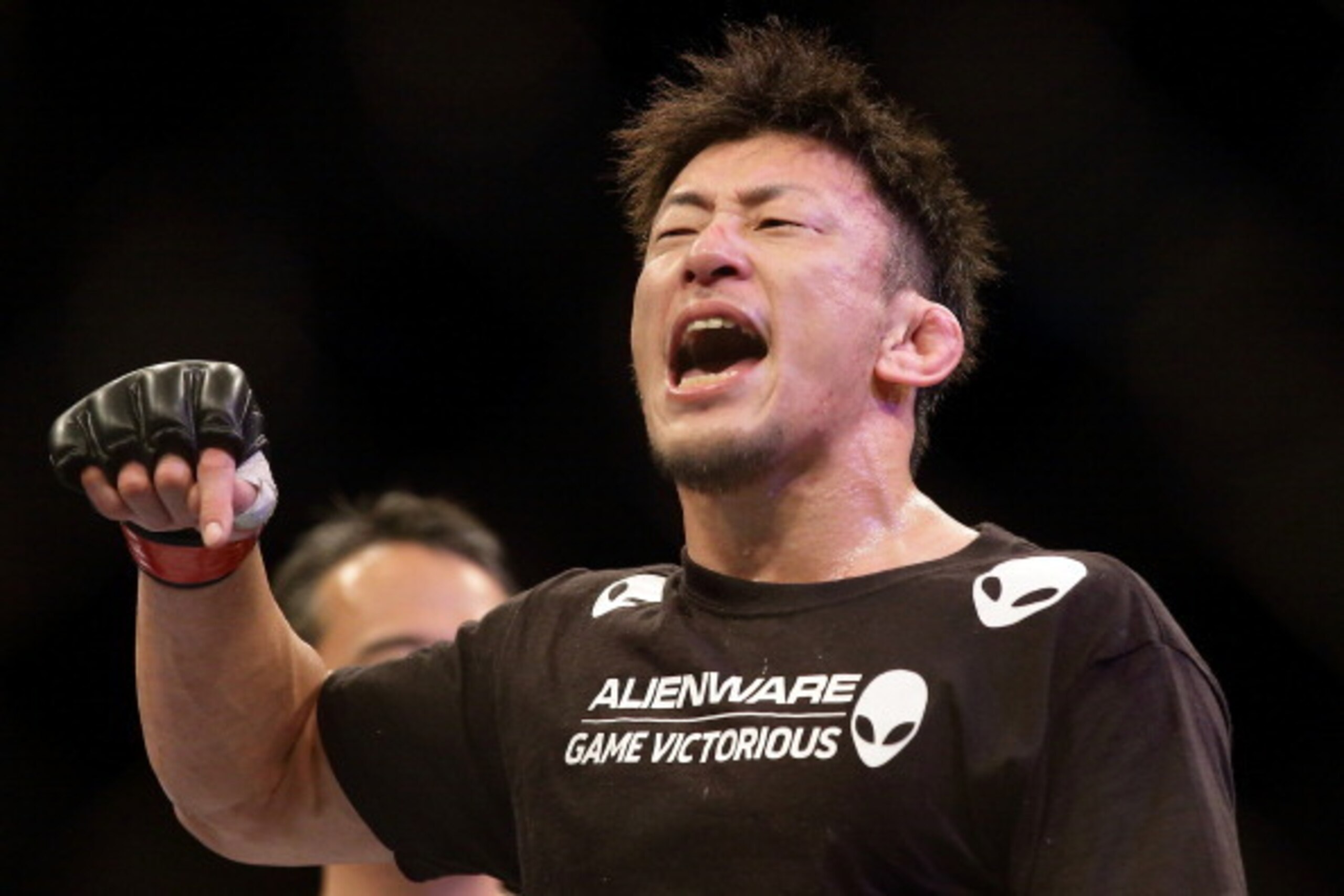 SINGAPORE - JANUARY 04:  Tatsuya Kawajiri reacts after defeating Sean Soriano during their UFC Fight Night Singapore featherweight bout at Marina Bay Sands on January 4, 2014 in Singapore.  (Photo by Suhaimi Abdullah/Getty Images)