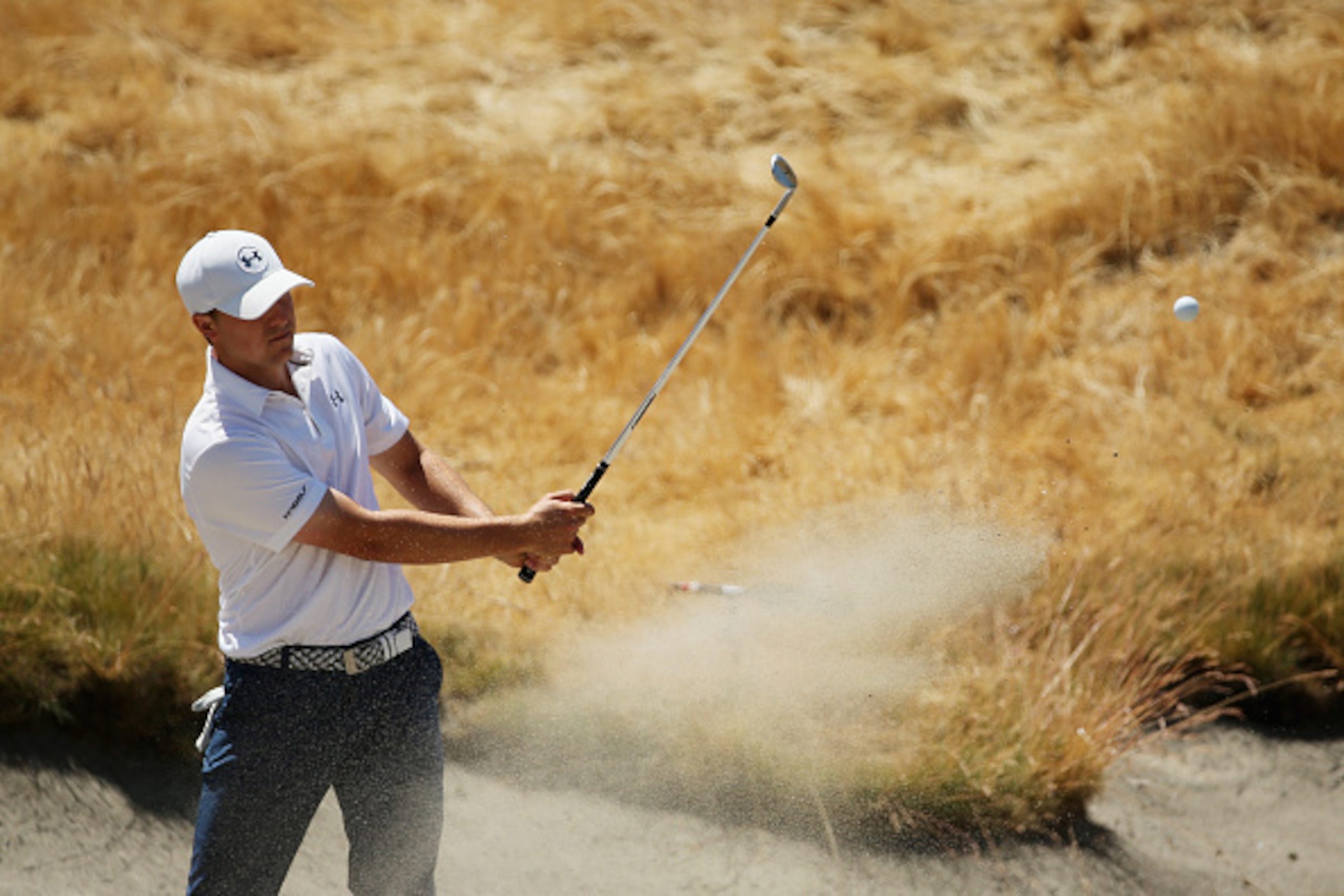 UNIVERSITY PLACE, WA - JUNE 17:  Jordan Spieth of the United States plays a bunker shot during a practice round prior to the start of the 115th U.S. Open Championship at Chambers Bay on June 17, 2015 in University Place, Washington.  (Photo by Mike Ehrman