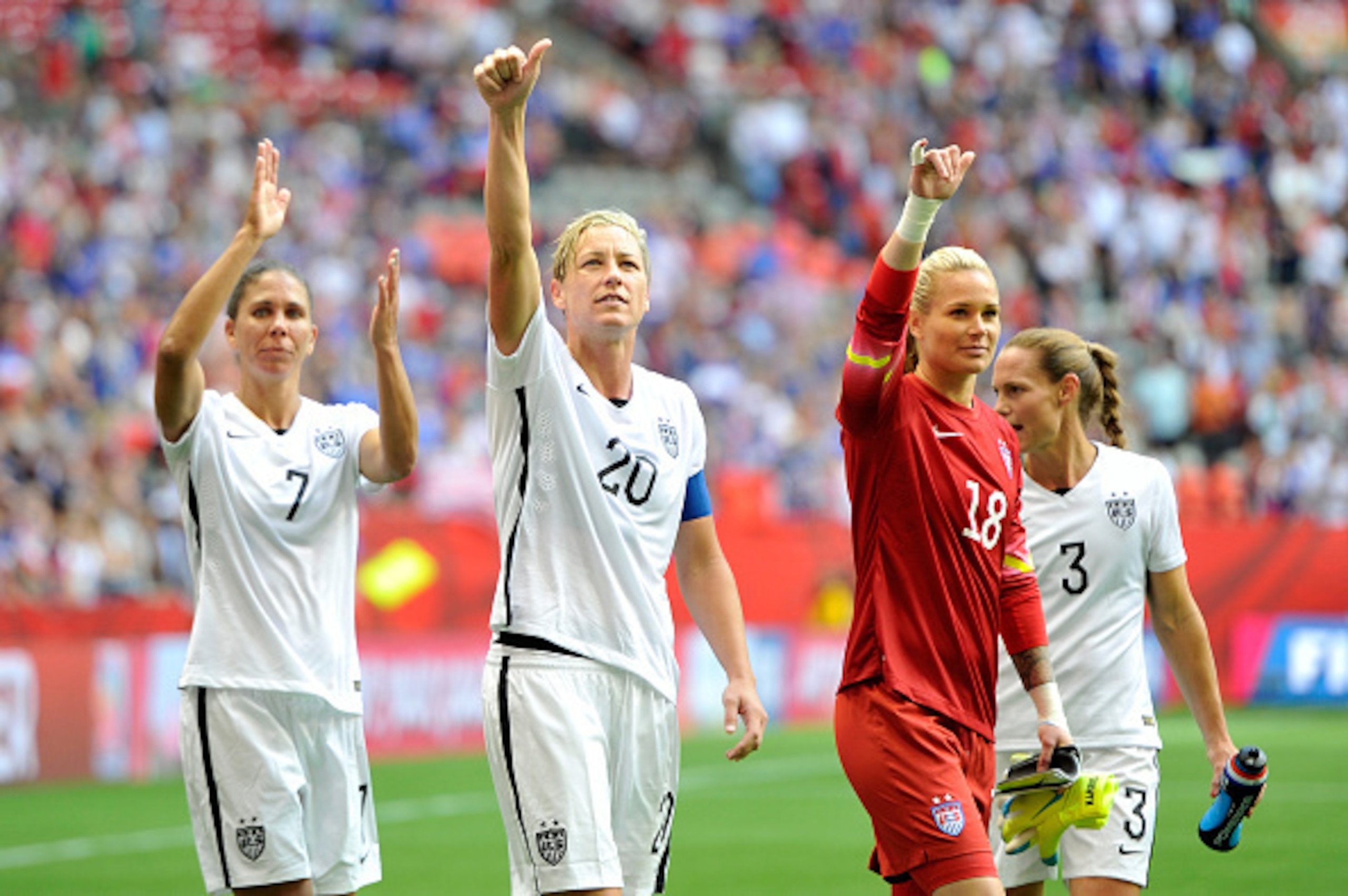 VANCOUVER, BC - JUNE 16:  Shannon Boxx #7, Abby Wambach #20, Ashlyn Harris #18, and Christie Rampone #3 of the United States celebrate with teammates after the 1-0 victory against Nigeria in the Group D match of the FIFA Women's World Cup Canada 2015 at B